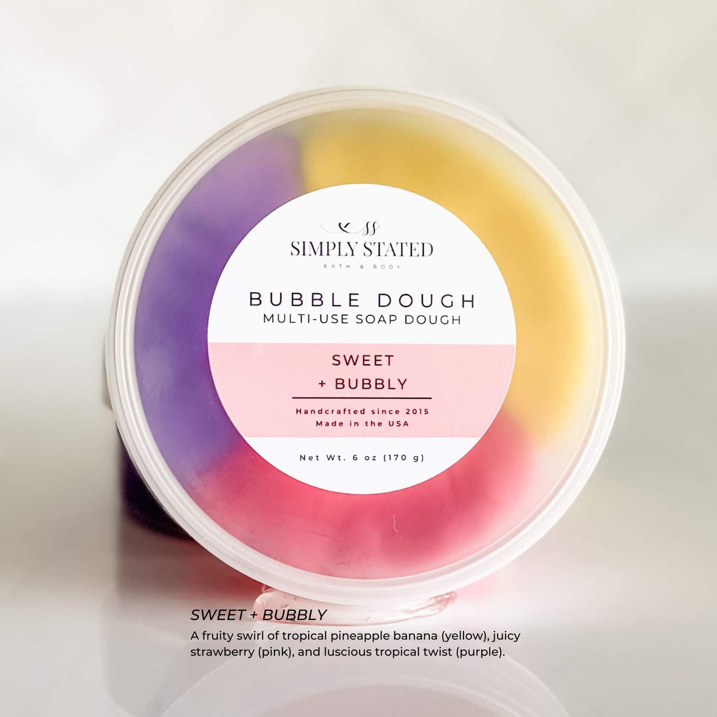 Simply Stated Bubble Dough in Sweet + Bubbly scent, a playful pink, purple, and yellow multi-use soap dough for kids. Soft, moldable, and perfect for bath time fun.