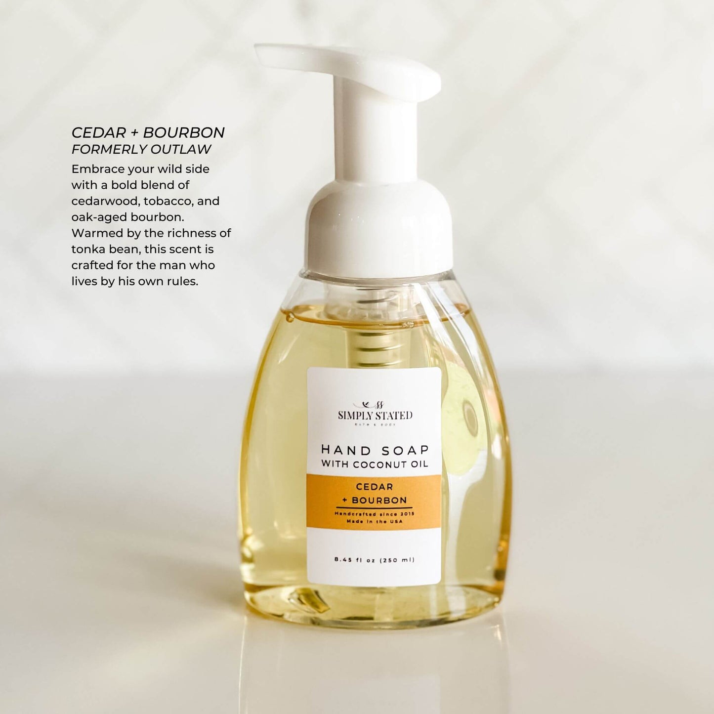 Cedar + Bourbon Men’s Foaming Hand Soap in white bottle with amber label