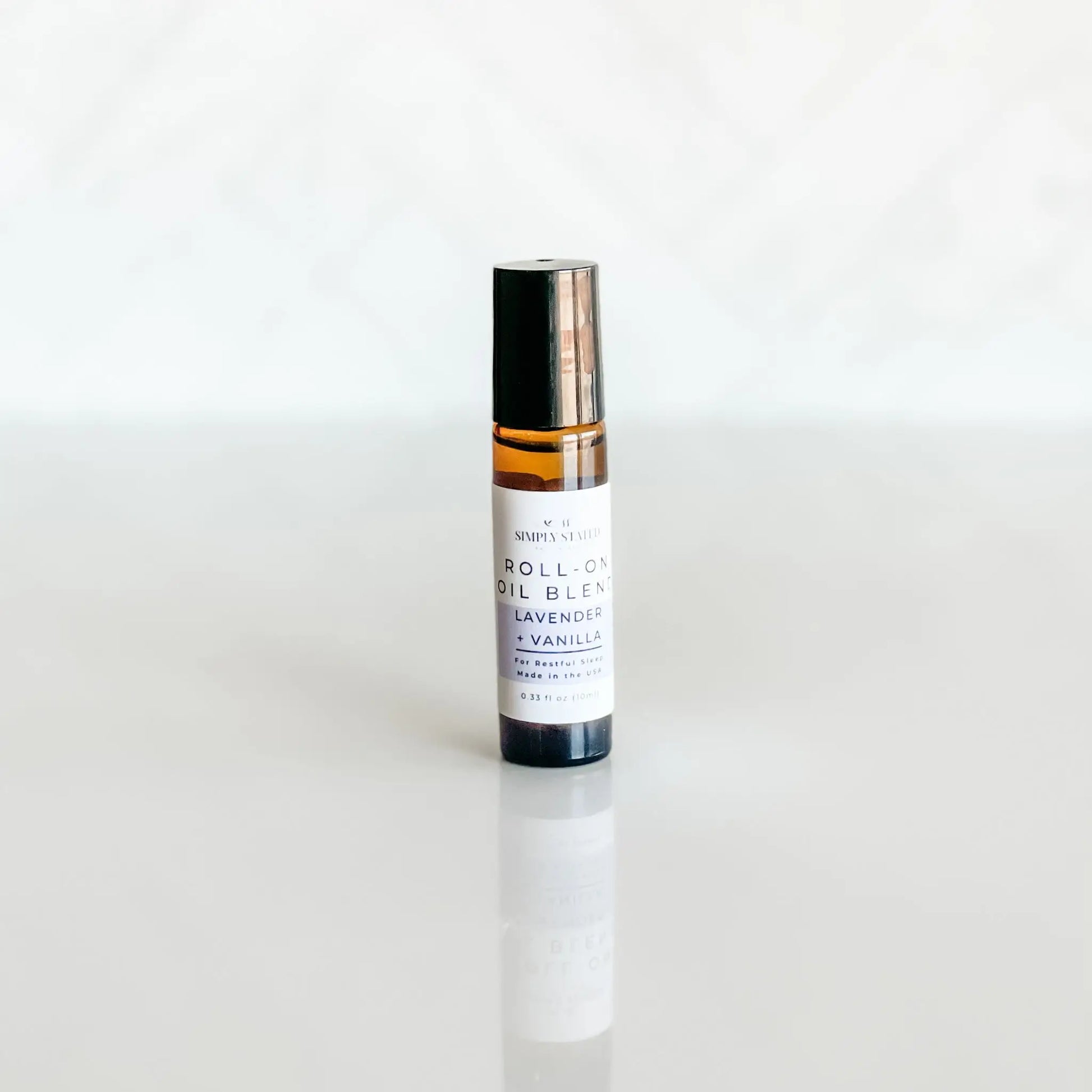 Roll-on oil blend bottle with lavender and vanilla on a white background