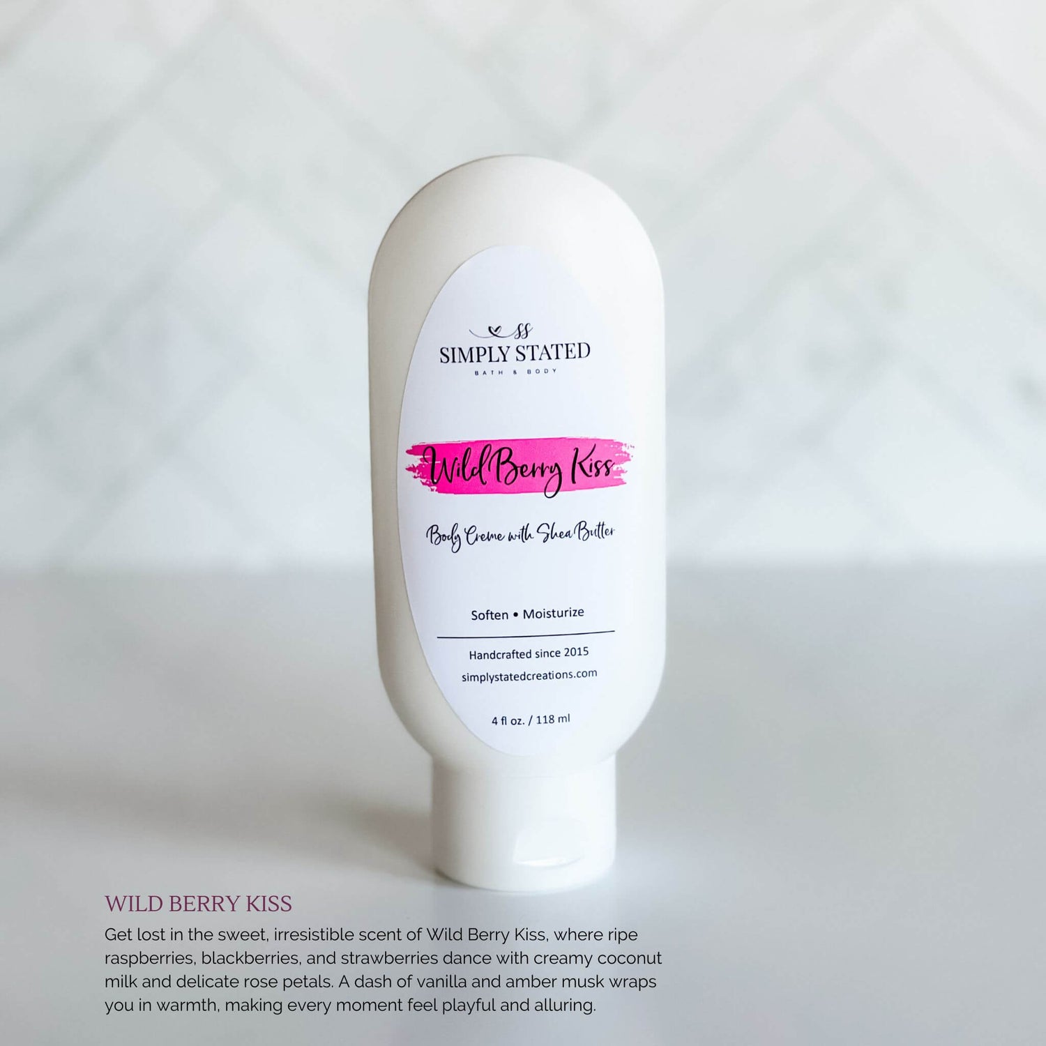 Simply Stated Bath & Body Wild Berry Kiss Body Creme bottle, a hydrating shea butter formula with a magenta label, set against a clean white background.