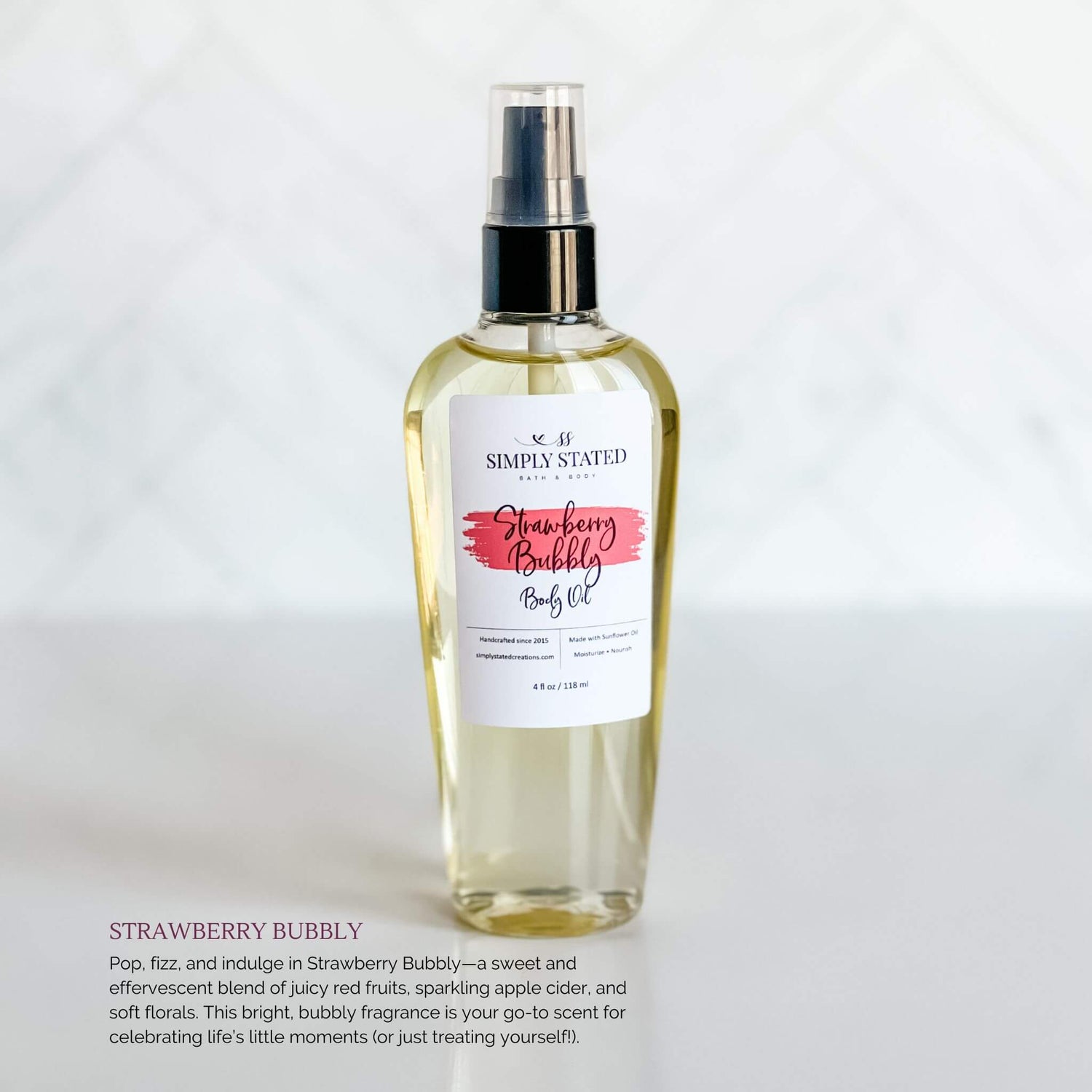 Simply Stated Bath & Body Strawberry Bubbly Body Oil in a clear glass spray bottle with a bright pink label, shown on a clean white background.