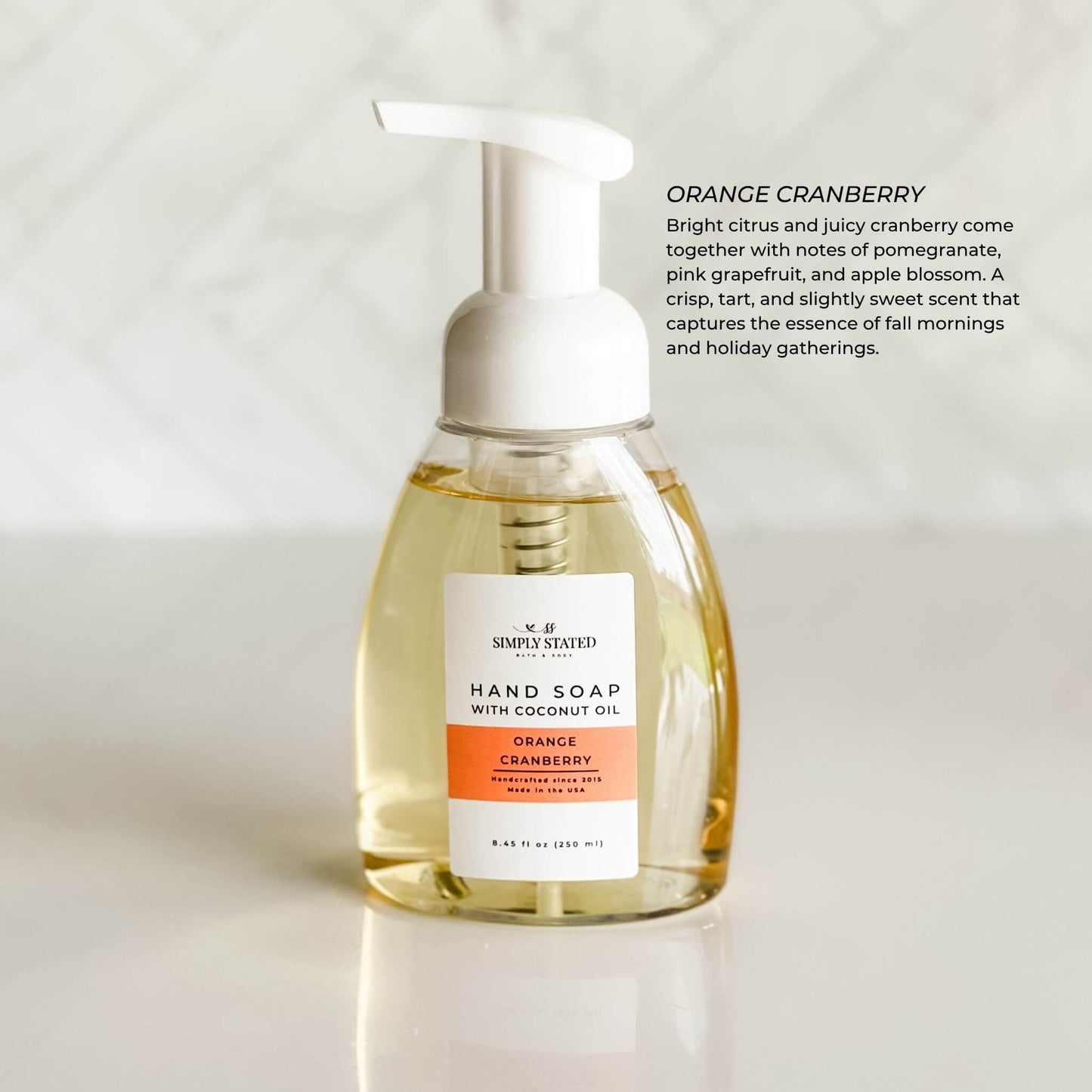 Orange Cranberry Foaming Hand Soap with crisp citrus scent description and white background