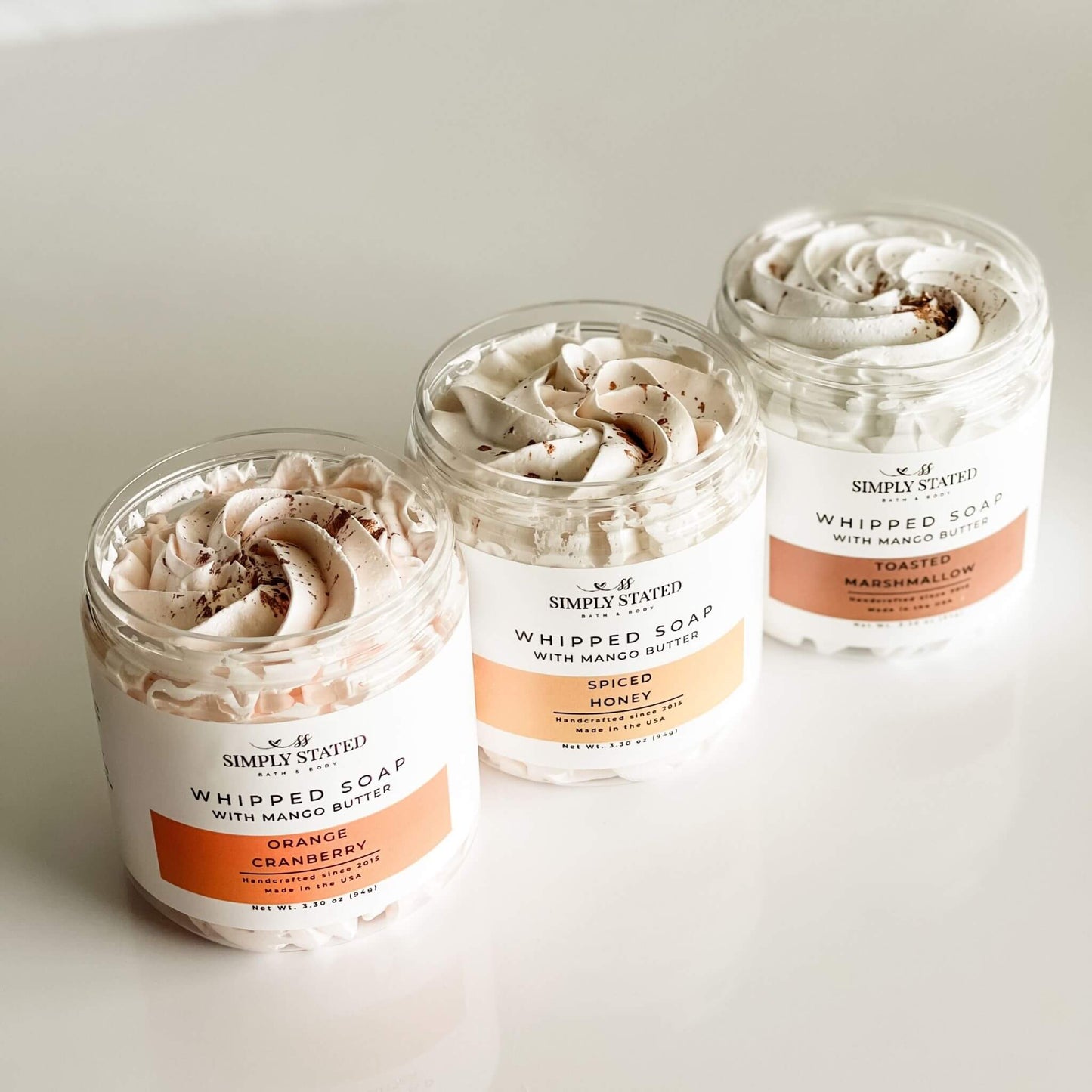Overhead view of Simply Stated Fall Whipped Soaps in Orange Cranberry, Spiced Honey, and Toasted Marshmallow