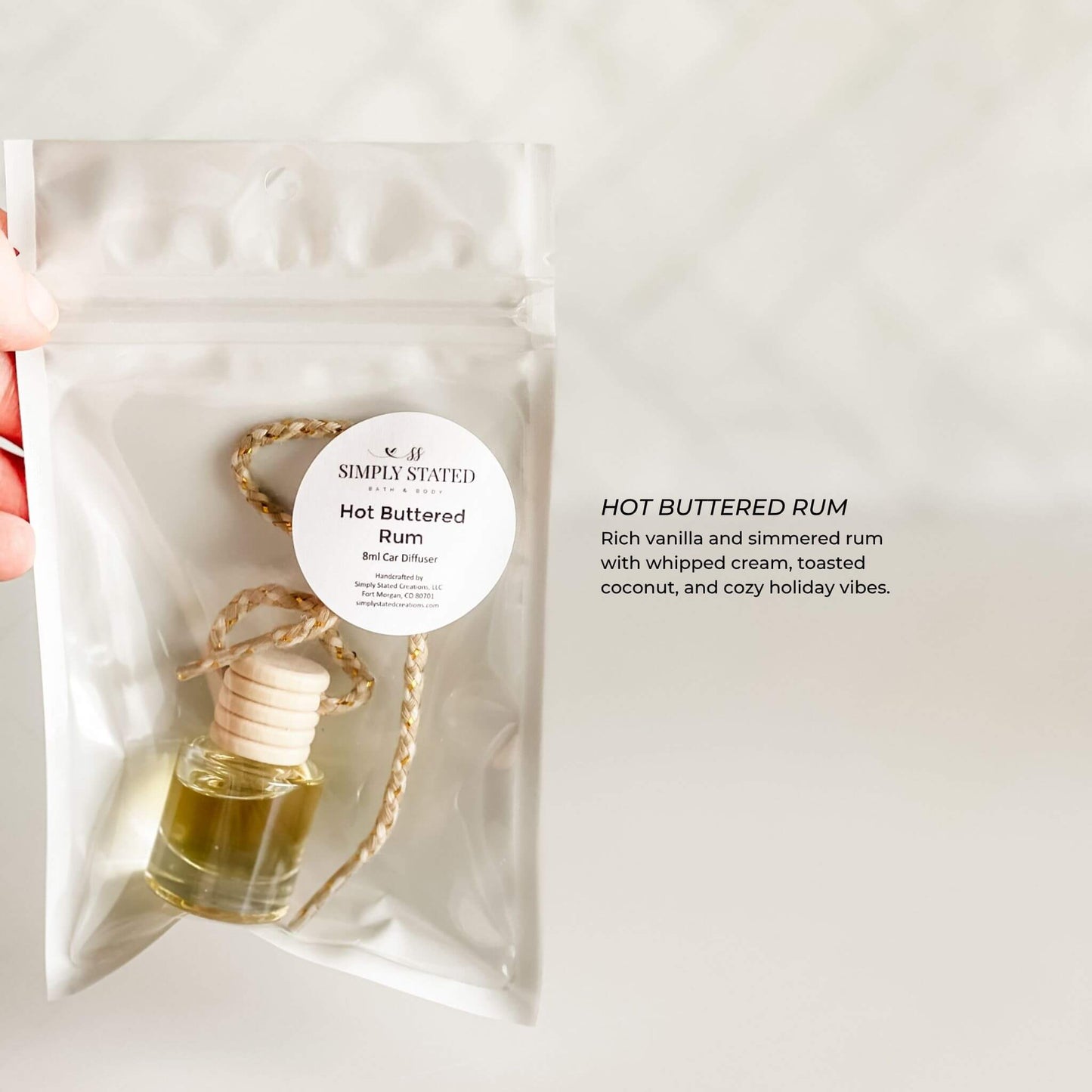 Hot Buttered Rum car air freshener in a clear packaging with a label on a white background