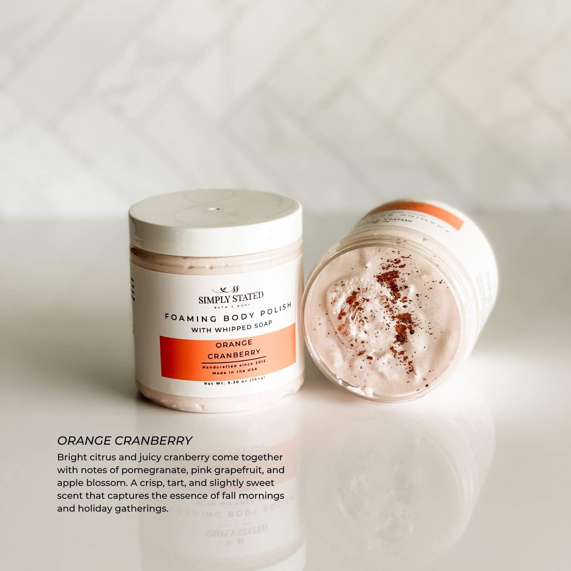Simply Stated Orange Cranberry Foaming Body Polish with soft pink whipped texture and fall scent description