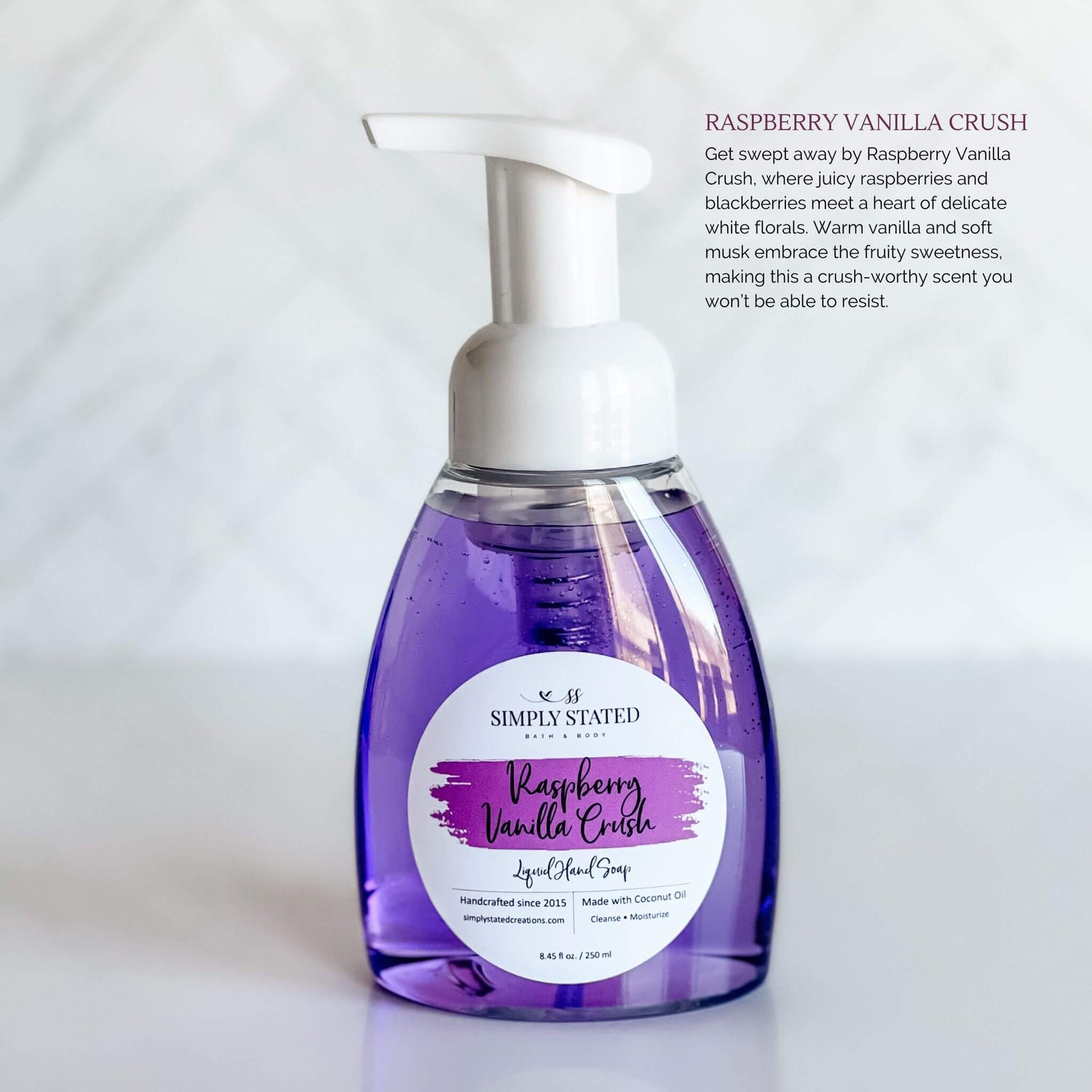 Simply Stated Bath & Body Raspberry Vanilla Crush Liquid Hand Soap in a clear pump bottle with vibrant purple soap, featuring a purple label, displayed on a white background.