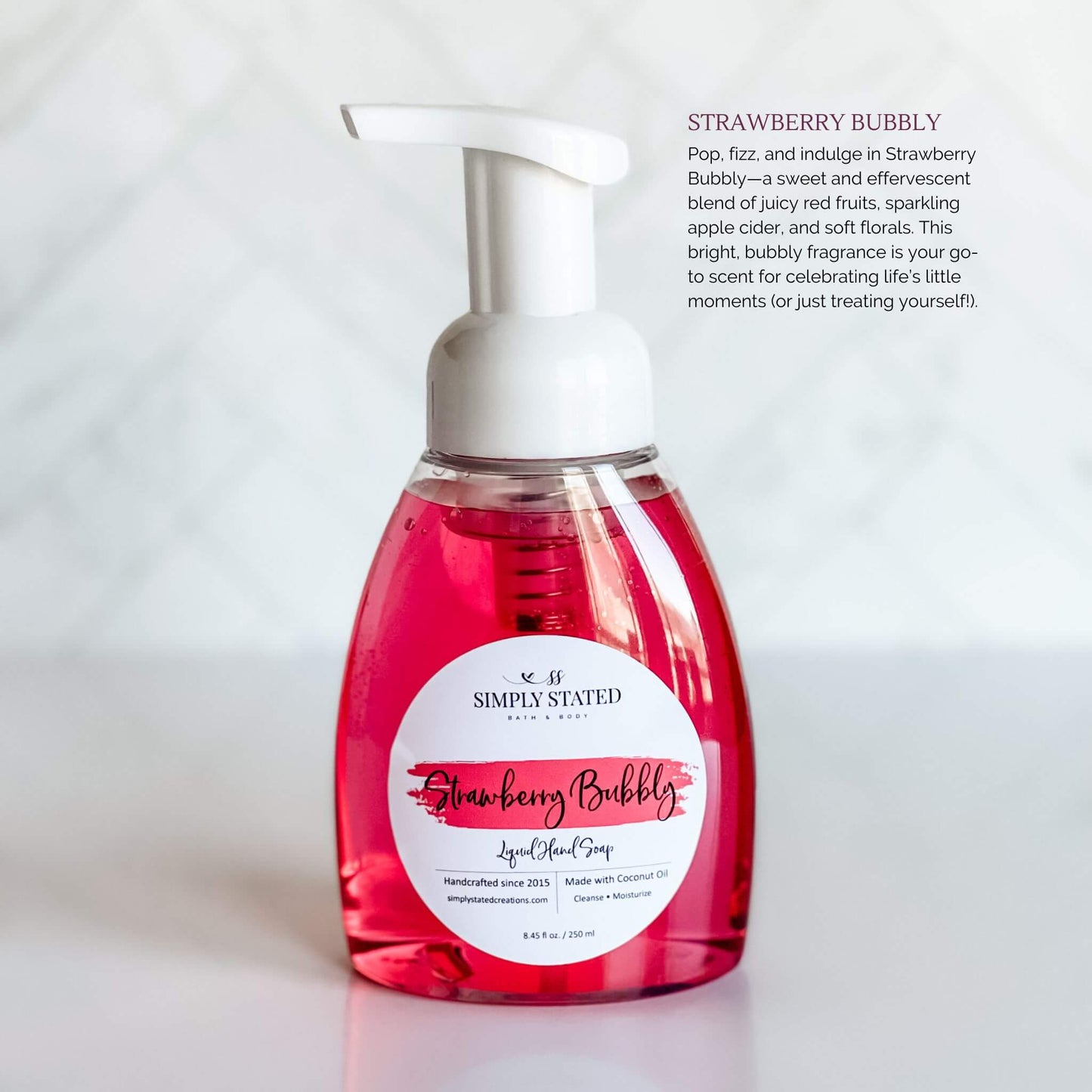 Simply Stated Bath & Body Strawberry Bubbly Liquid Hand Soap in a clear pump bottle with bright pink soap, featuring a pink label, set against a white background.