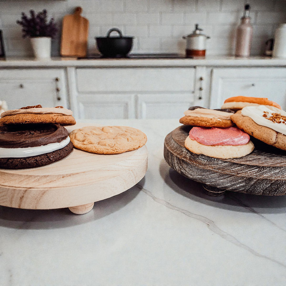 Handmade round wooden pedestal tray with raised feet! Perfect for displaying jewelry, candles & plants. Rustic farmhouse style in 2 finishes. Shop Gia Roma! #pedestaltray #farmhousedecor #jewelrydisplay #elevatedtray