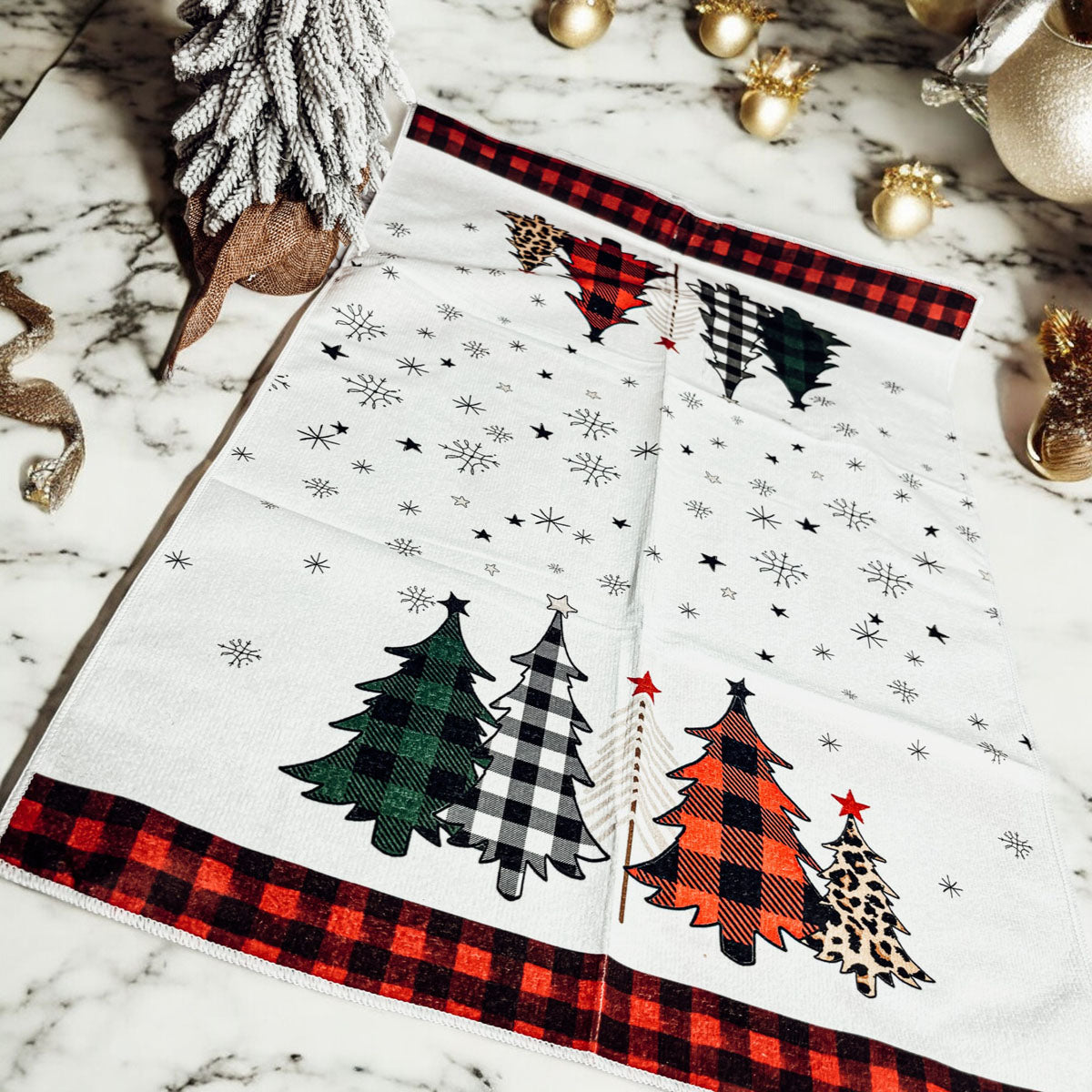 Red and black gingham kitchen towel showcasing colorful gingham Christmas trees
Christmas dish towel with red and black gingham ends and festive snowflake accents
Holiday hand towel featuring black, green, and red gingham Christmas trees