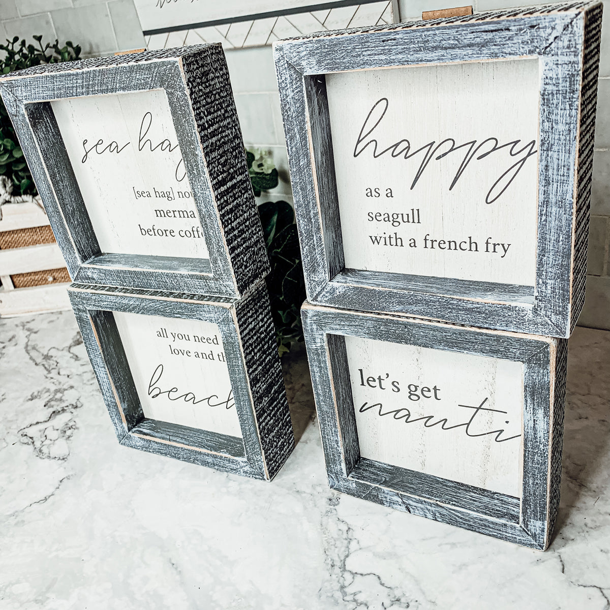 Beach house wall art featuring Let's Get Nauti text in farmhouse style frame