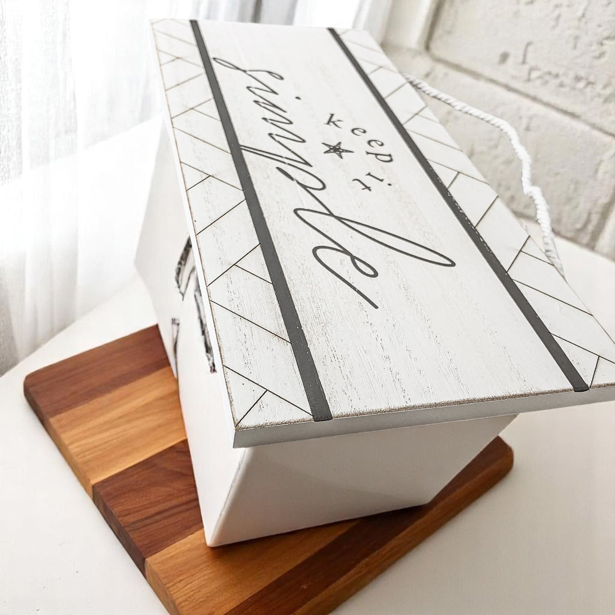 White wooden sign with geometric border and starfish accent