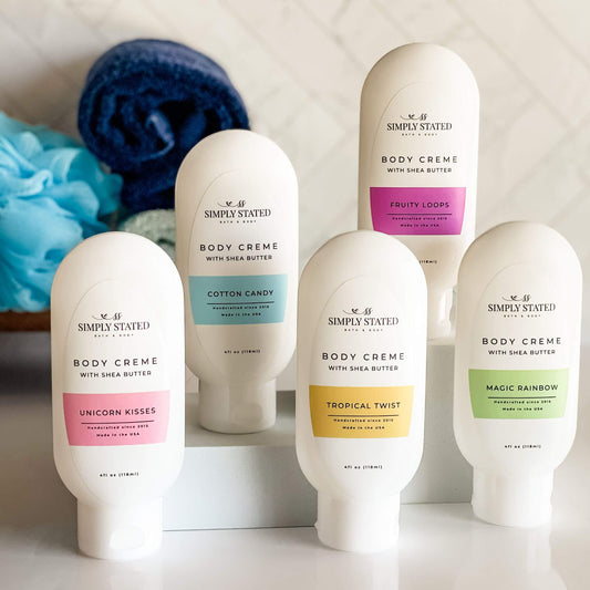 Collection of Simply Stated Body Creme bottles with colorful labels on a neutral background