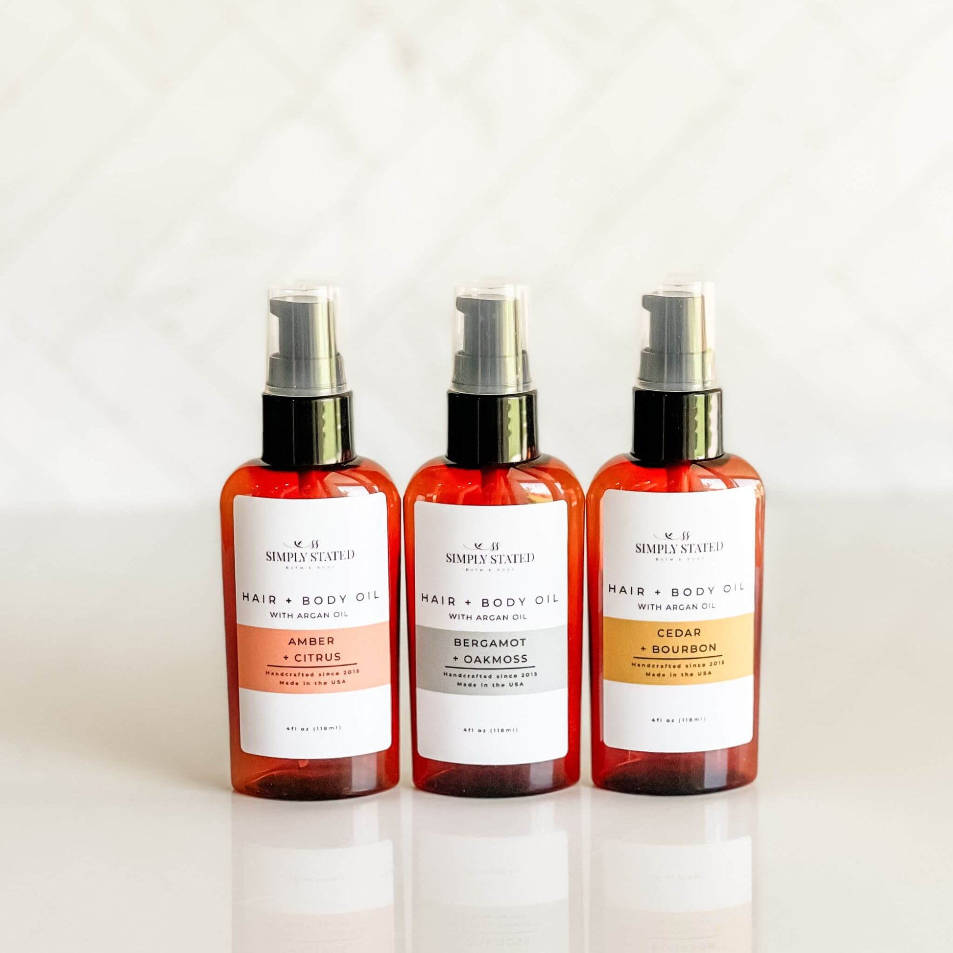 Group shot of Simply Stated Men’s Beard + Body Oil trio in modern packaging