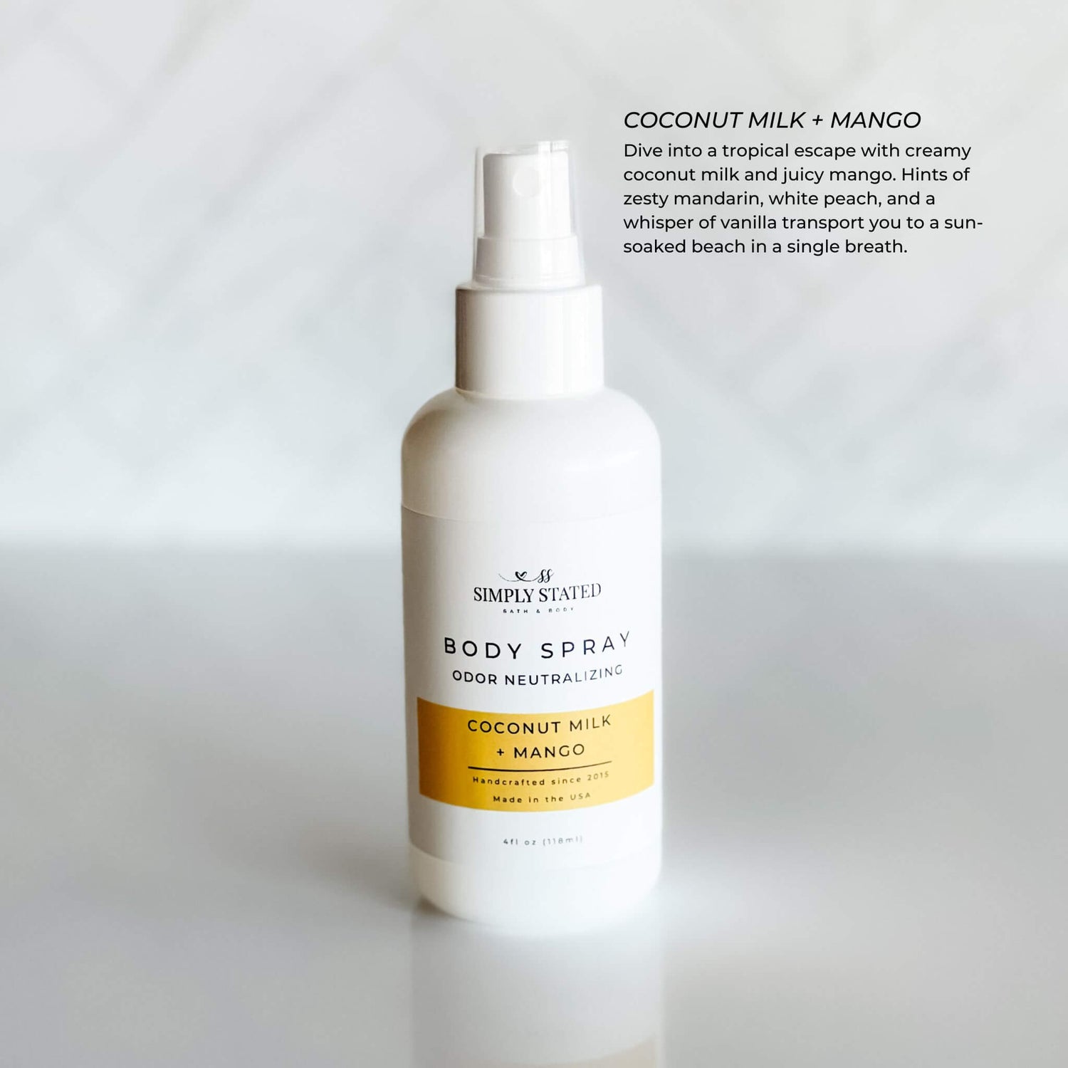 Simply Stated Coconut Milk + Mango Body Spray in a 4oz white bottle with odor-neutralizing formula. A tropical scent blending creamy coconut milk and juicy mango for a fresh and exotic fragrance.