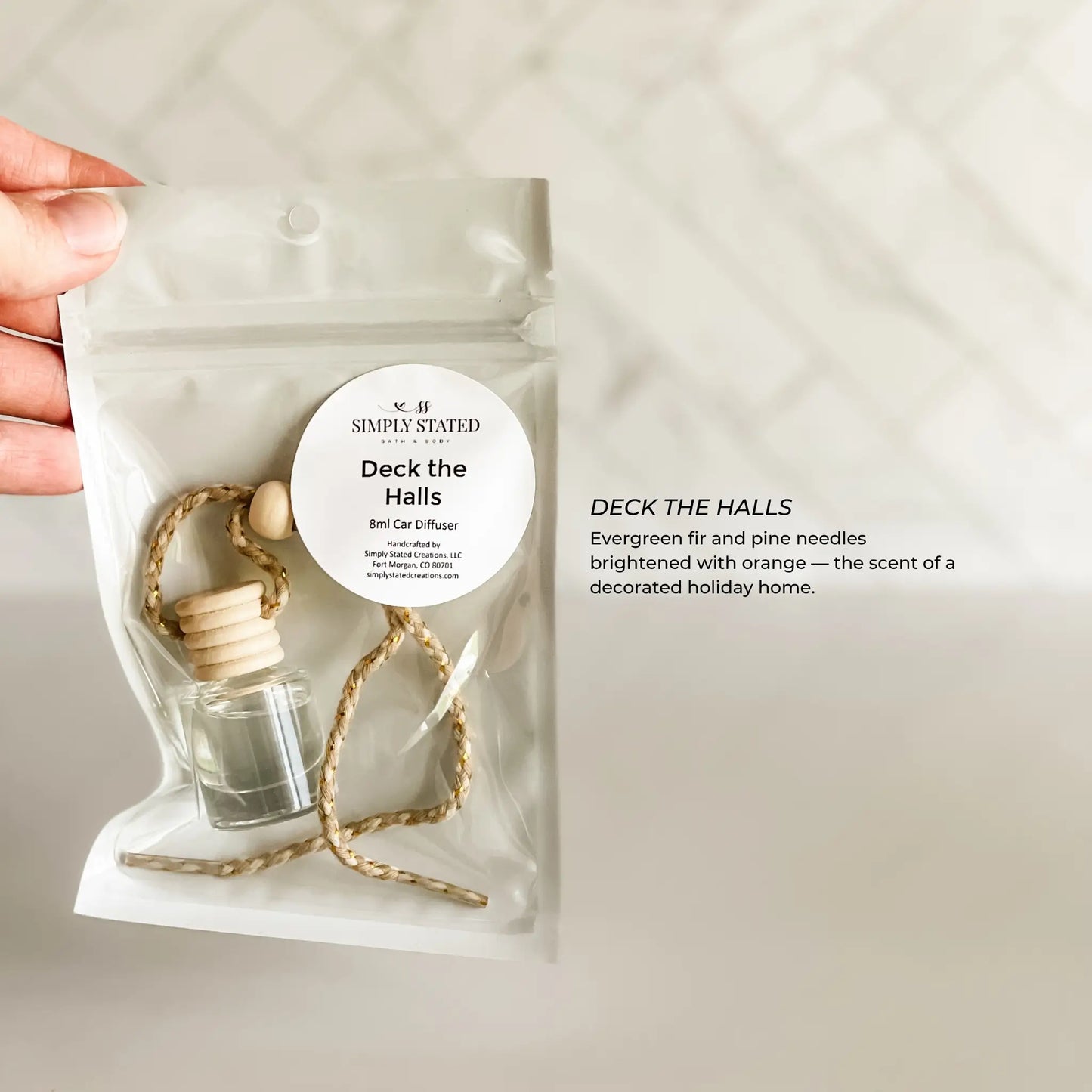 Car diffuser with 'Simply Stated' label on a plain background