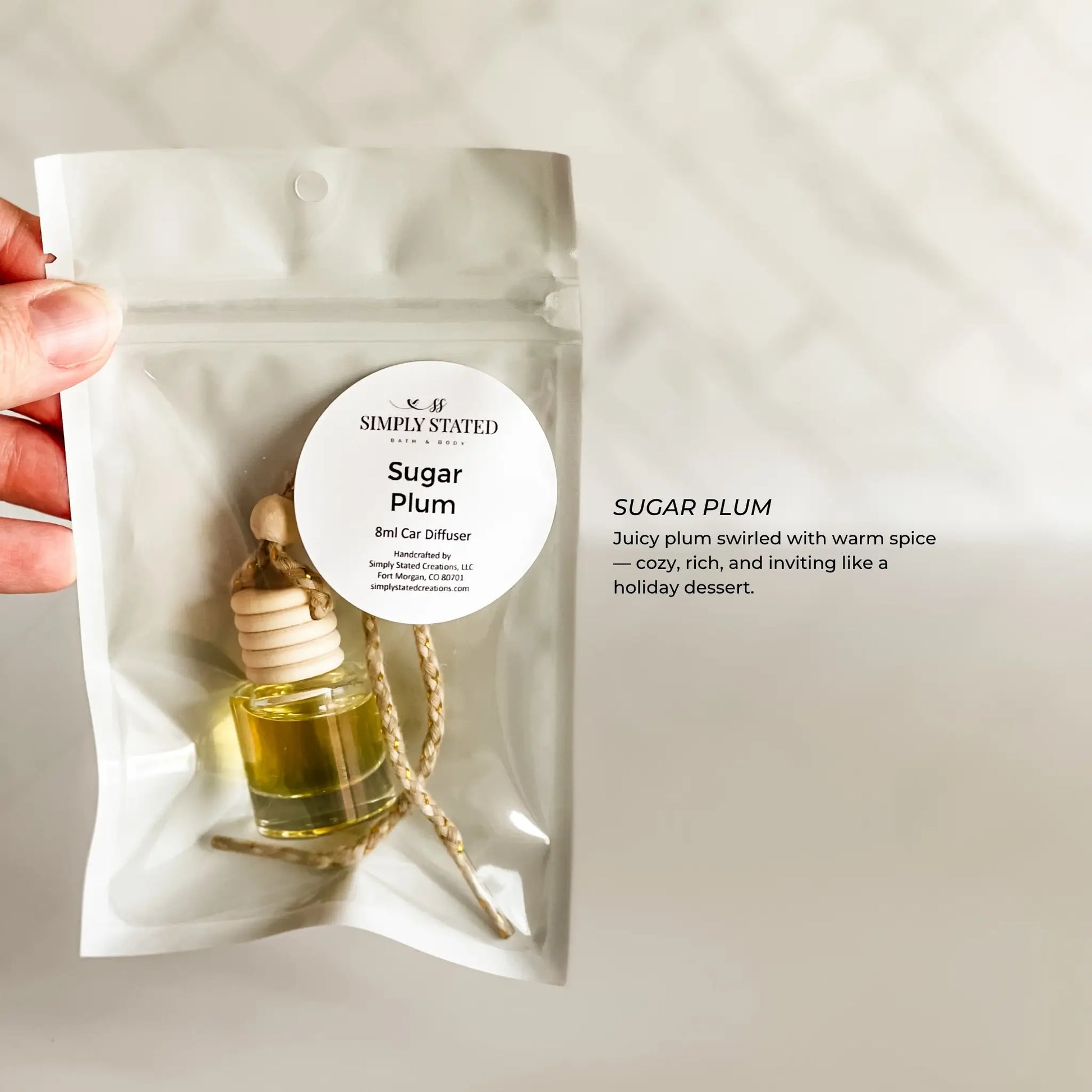 Car diffuser with 'Sugar Plum' fragrance on a plain background