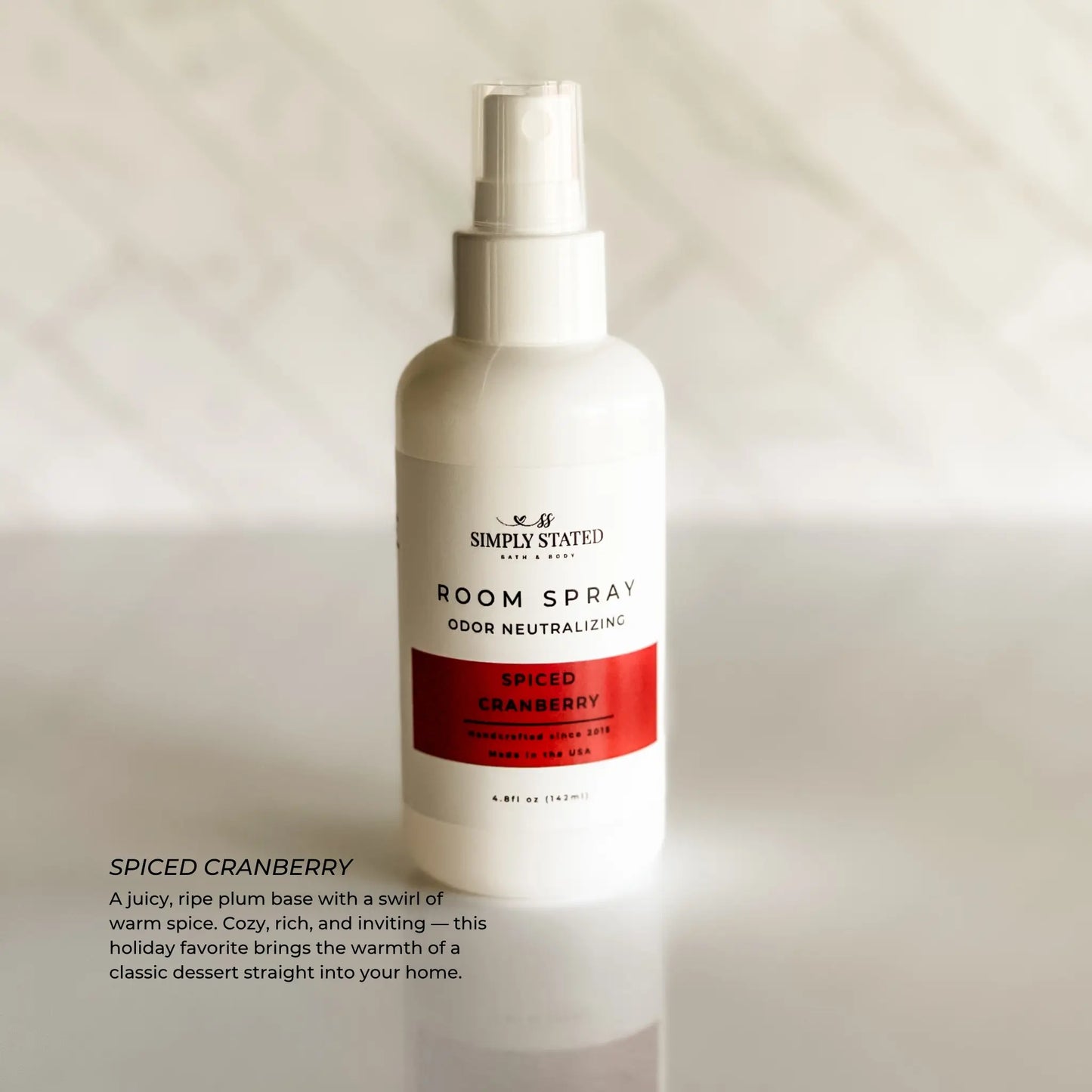 Spiced Cranberry room spray bottle on a neutral background