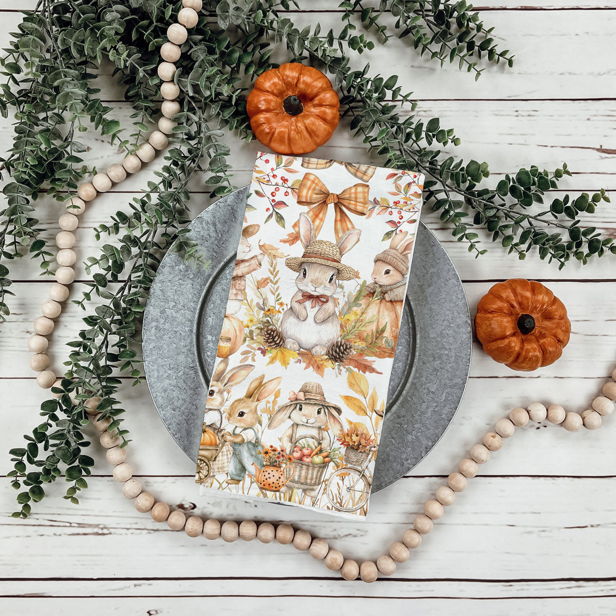 autumn leaf and bunny print flour sack dish towel
pumpkin spice season bunny kitchen towel
fall tea towel with bunnies pushing pumpkin cart
autumn bunny towel styled with pumpkins and cookbooks
cute woodland rabbit towel for nursery or play kitchen