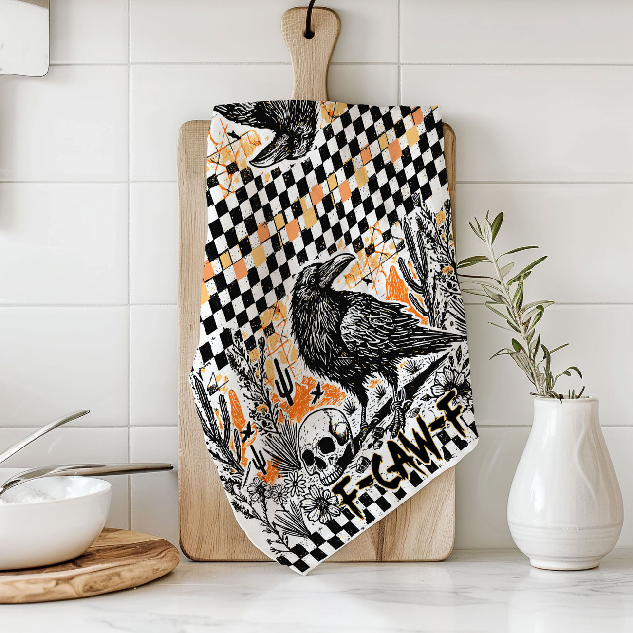 edgy fall kitchen towel with crow skull and checkered border
funny fall tea towel for halloween parties crow design
black bird halloween hand towel with orange grunge background
crow and jack o lantern style skull towel for spooky décor
witchy fall kitchen towel with raven and skull print