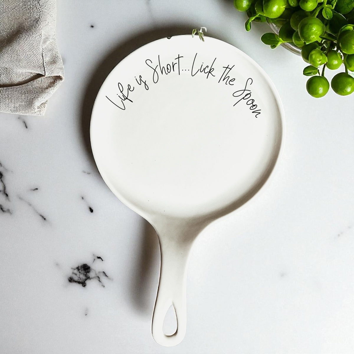 Ceramic spoon rest with baking quote displayed in modern white kitchen
Life is Short Lick the Spoon ceramic spoon holder with wooden spoon and gift tag