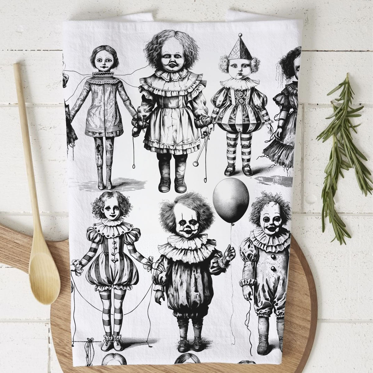gothic horror kitchen towel with eerie dolls and clowns
spooky season dish towel with black and white doll art
creepy children doll halloween towel on rustic board
disturbing clown face towel for scary halloween kitchen