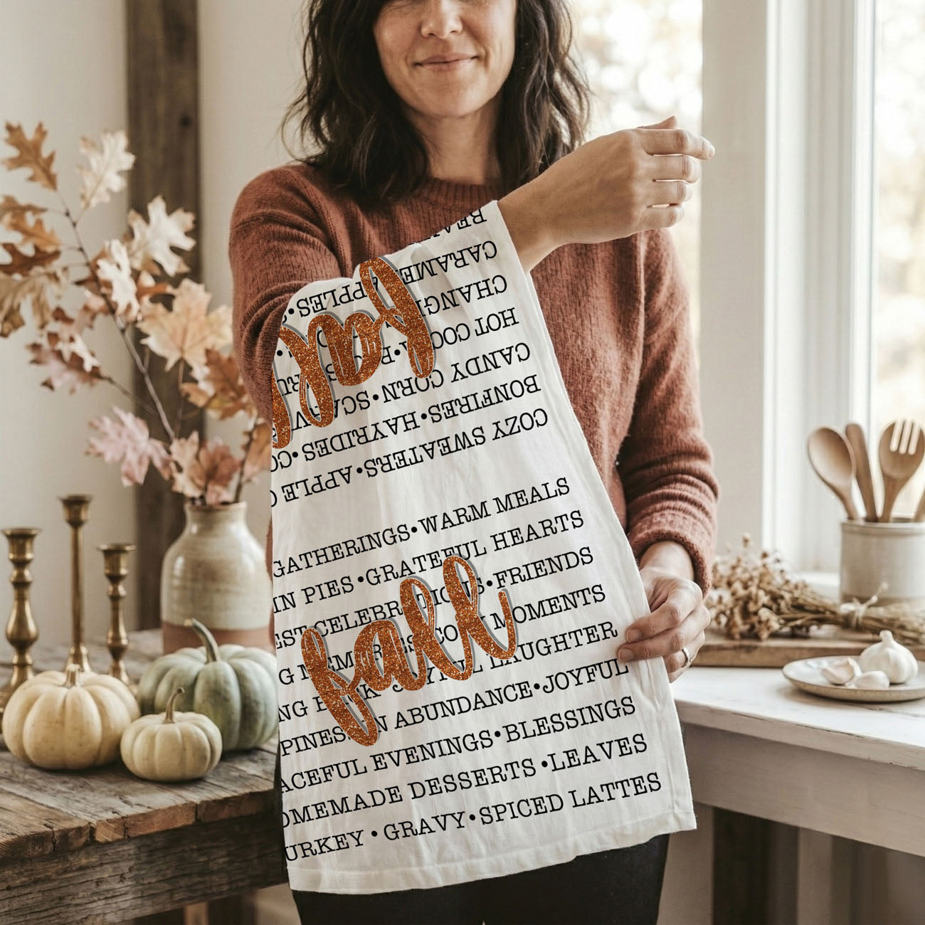 fall phrases flour sack towel rolled in kitchen gift basket
seasonal word collage towel for autumn table décor
fall script towel accenting white farmhouse kitchen
autumn words tea towel next to pie and cinnamon sticks