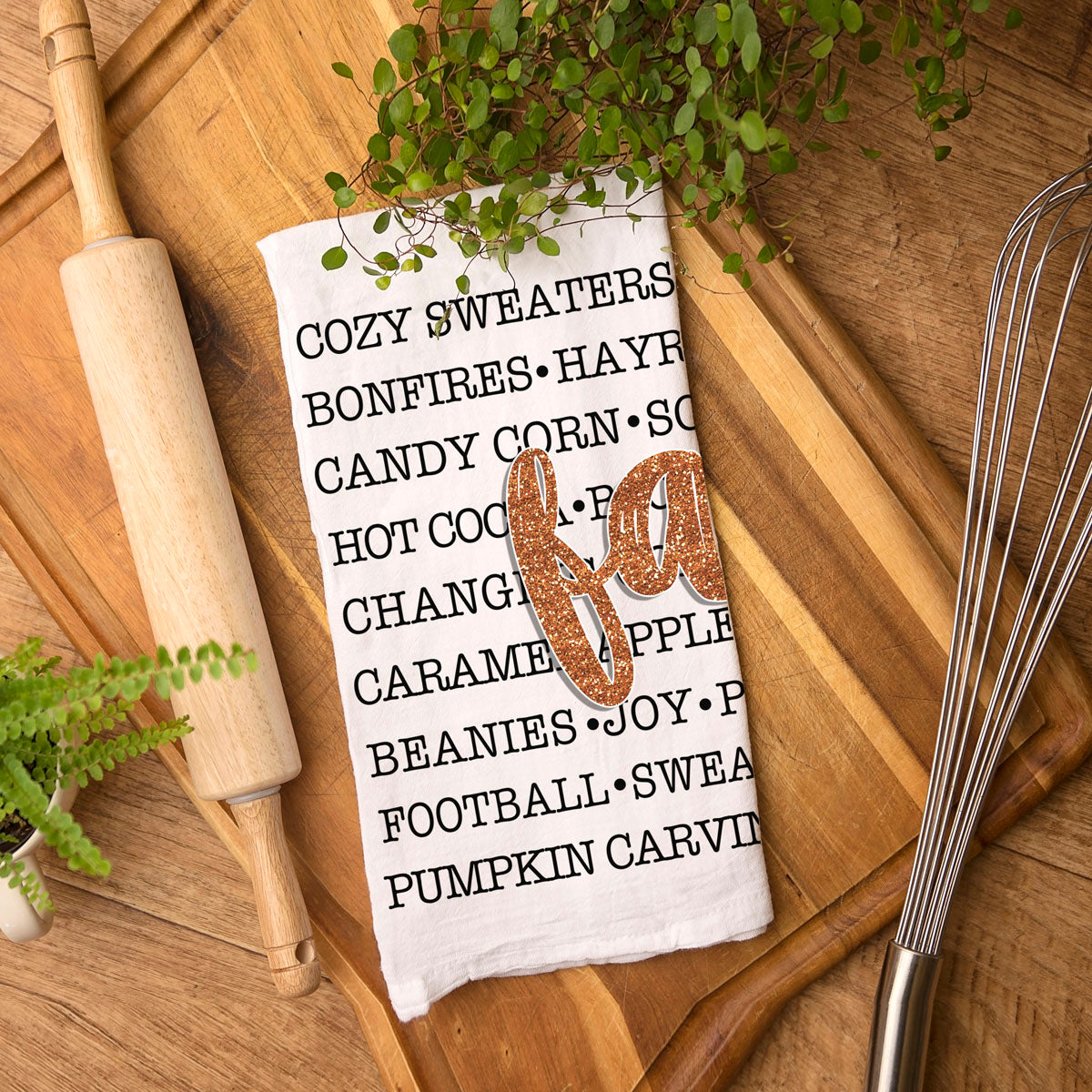 autumn kitchen accessory with black word art and orange script
fall word list towel used as bread basket liner
seasonal hostess gift fall typography dish towel
cozy entryway display with framed art and fall words towel