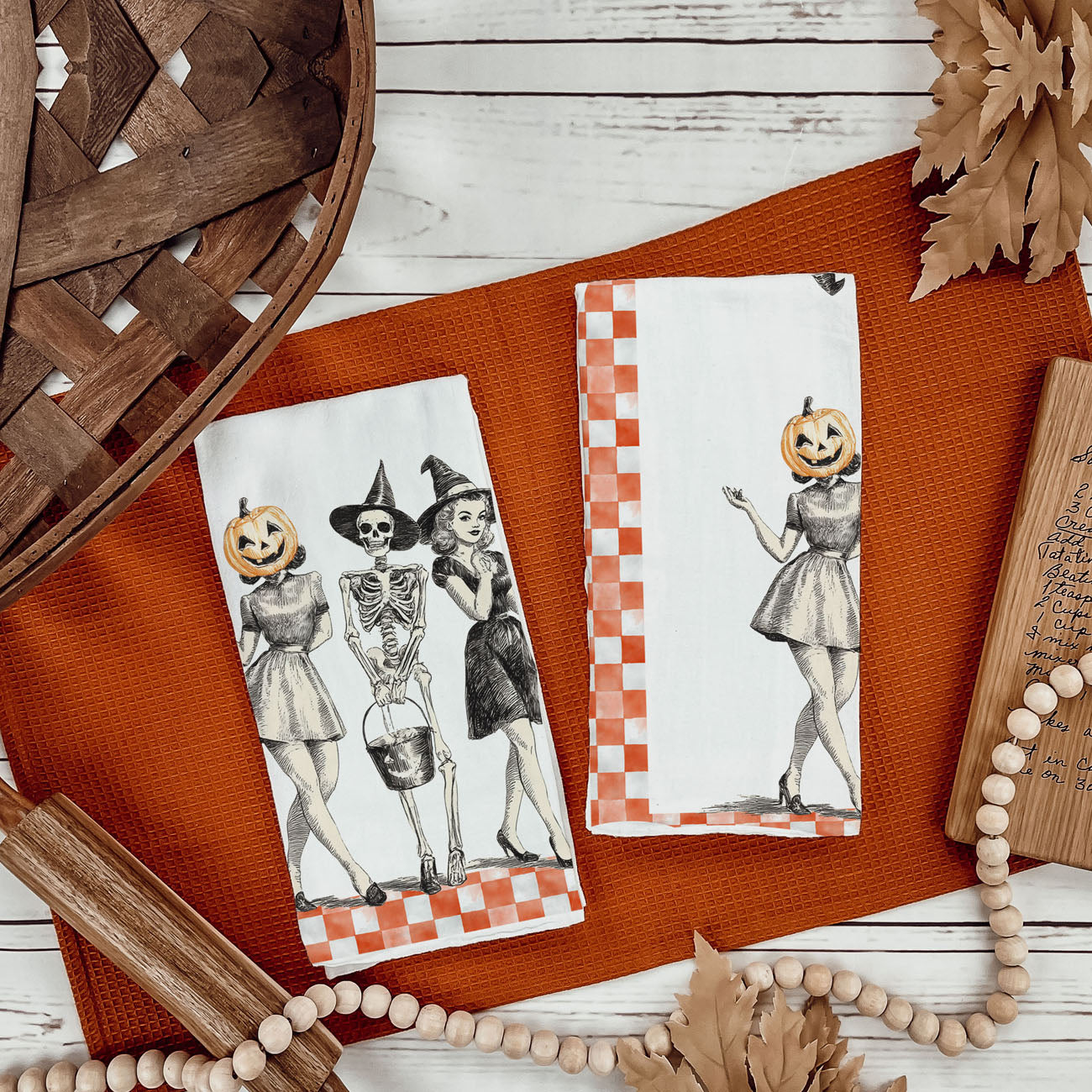 nostalgic halloween kitchen towel with classic skeleton trio
orange gingham spooky season towel for retro fall décor
mid century vintage halloween towel with genie style witch
classic halloween ladies towel with pumpkin head and wand