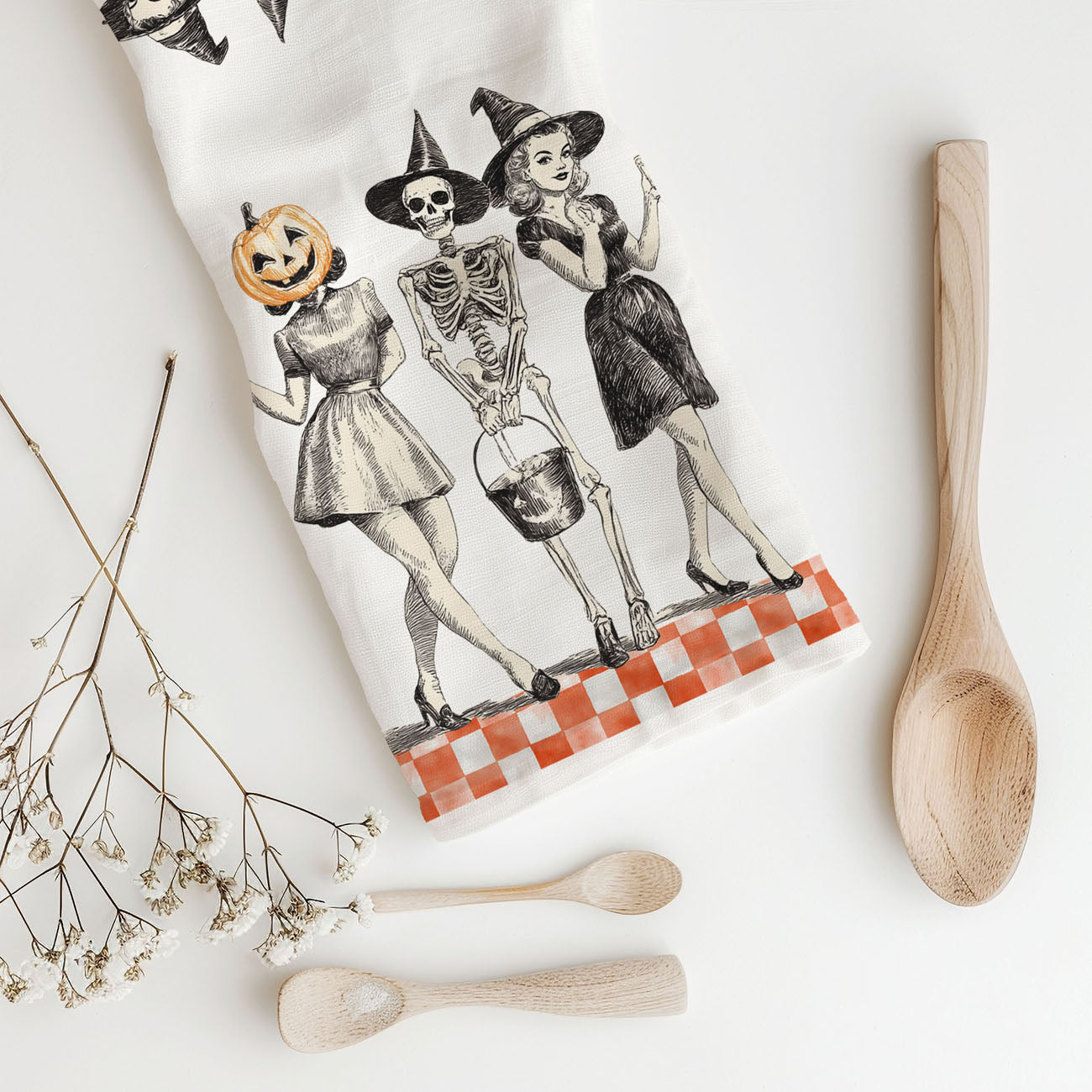 vintage style skeleton kitchen towel with pumpkin head friend
retro halloween flour sack towel with three ghoul squad girls
orange checkerboard halloween towel with vintage witch illustration
mid century style halloween dish towel pumpkin woman and skeleton