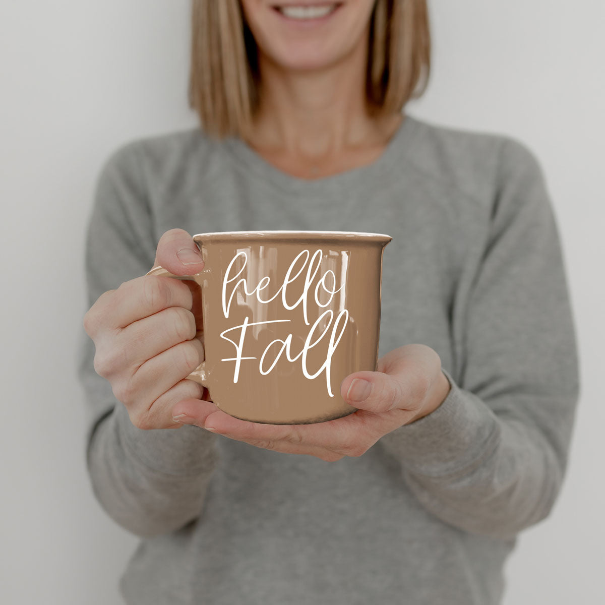 simple hello fall mug with neutral colors
hello fall mug styled with pumpkins and sweater
hello fall ceramic mug for cozy fall nights