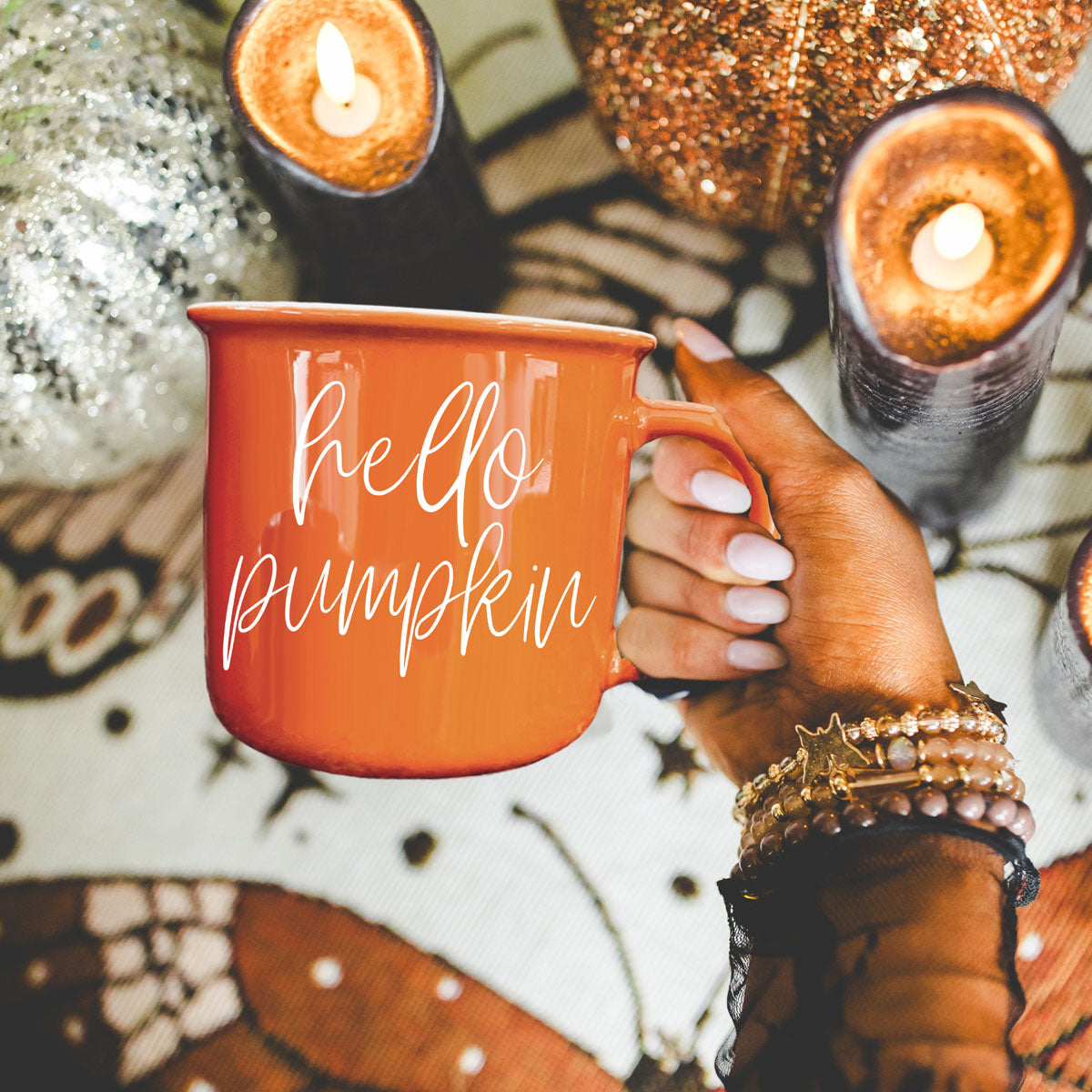 fall coffee cup with seasonal candles
orange mug on marble countertop with cinnamon
autumn beverage mug for latte and cocoa
fall breakfast setup with orange coffee mug