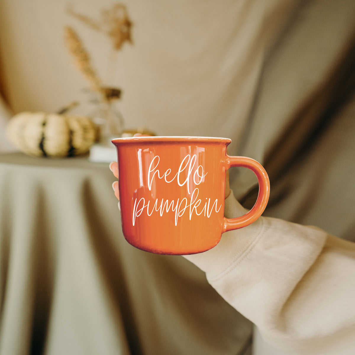 hello pumpkin mug on bed with blankets and pillows
hello pumpkin mug paired with fall wall art
hello pumpkin coffee cup with manicured nails