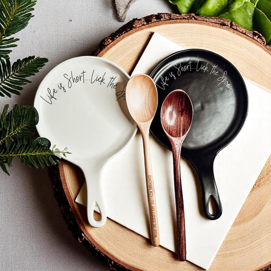 White ceramic spoon rest with Life is Short Lick the Spoon quote and matching wooden spoon gift set
Black ceramic spoon rest with humorous baking quote and wooden spoon gift set