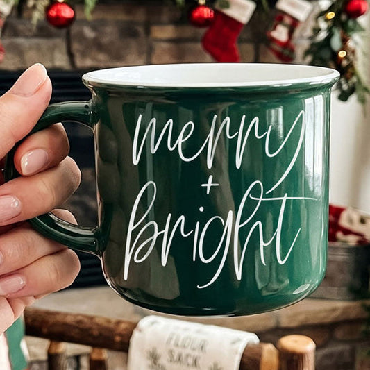 Christmas coffee mug, Merry & Bright mug, holiday ceramic mug, festive coffee cup, Christmas hot cocoa mug, holiday drinkware, Christmas kitchen decor, farmhouse Christmas mug, cozy winter mug, Christmas gift idea, holiday hostess gift, stocking stuffer, coffee lover gift, Christmas coffee bar decor.
Christmas mug with festive phrase and classic colors
Ceramic Christmas mug for home and gift shops