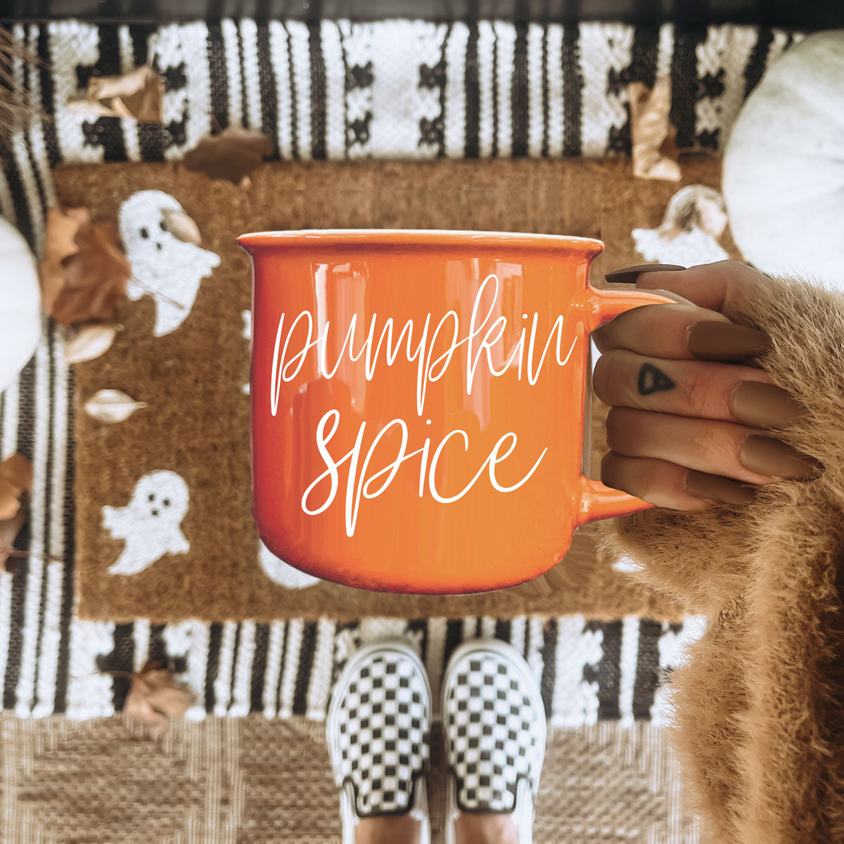 pumpkin spice latte mug and plaid scarf
pumpkin spice mug styled with fall decor
pumpkin spice autumn mug on couch with pillows
pumpkin spice latte cup with donut and coffee