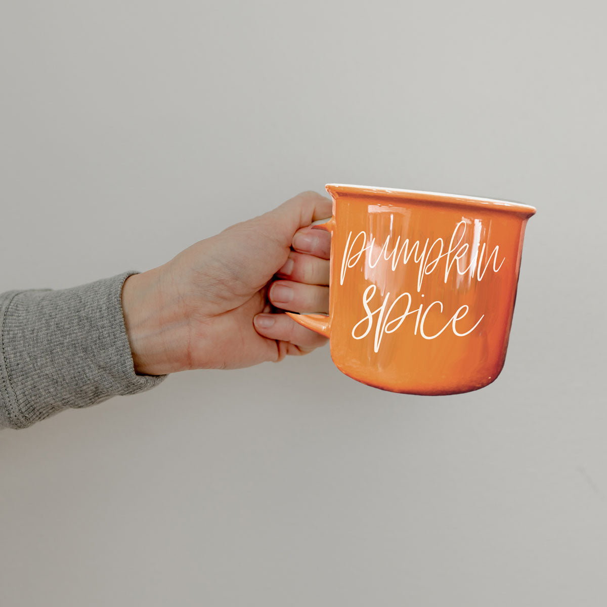 pumpkin spice latte mug on kitchen island
pumpkin spice mug with candle and faux pumpkins
pumpkin spice coffee cup by window with rain
pumpkin spice latte mug with book and glasses