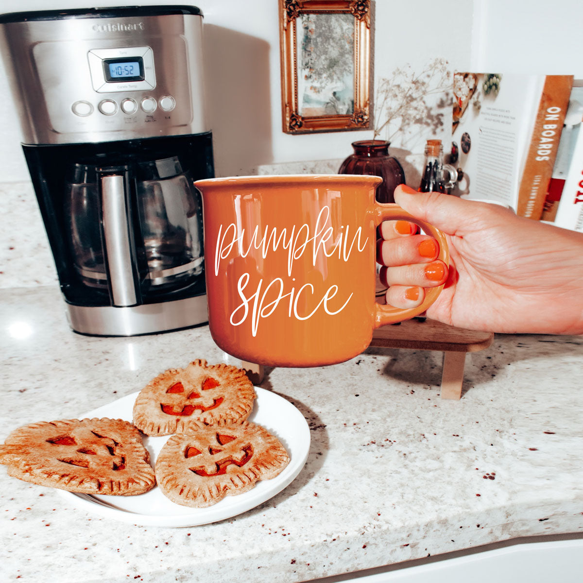 autumn living room coffee table decor with mug
seasonal drinkware display with multiple fall mugs
halloween themed bar cart with coffee mugs
fall apartment decor with orange accent mug