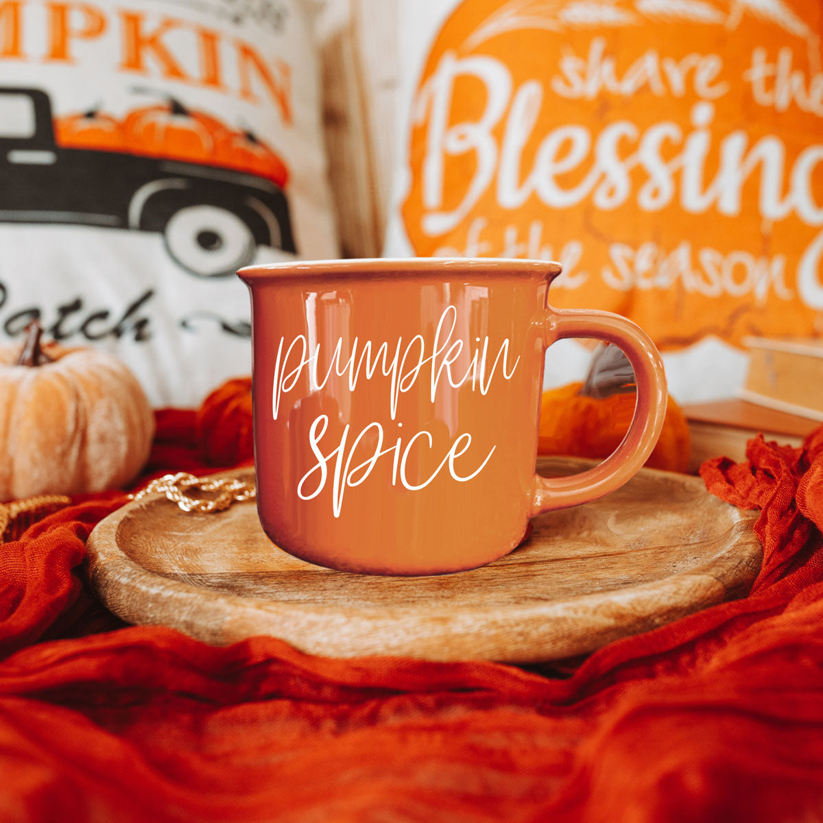 autumn coffee mug next to jack o lantern
orange mug with fall foliage background
fall drinkware styled with mini pumpkins and candles
halloween hot cocoa mug for spooky movie night
autumn kitchen counter with seasonal orange mug