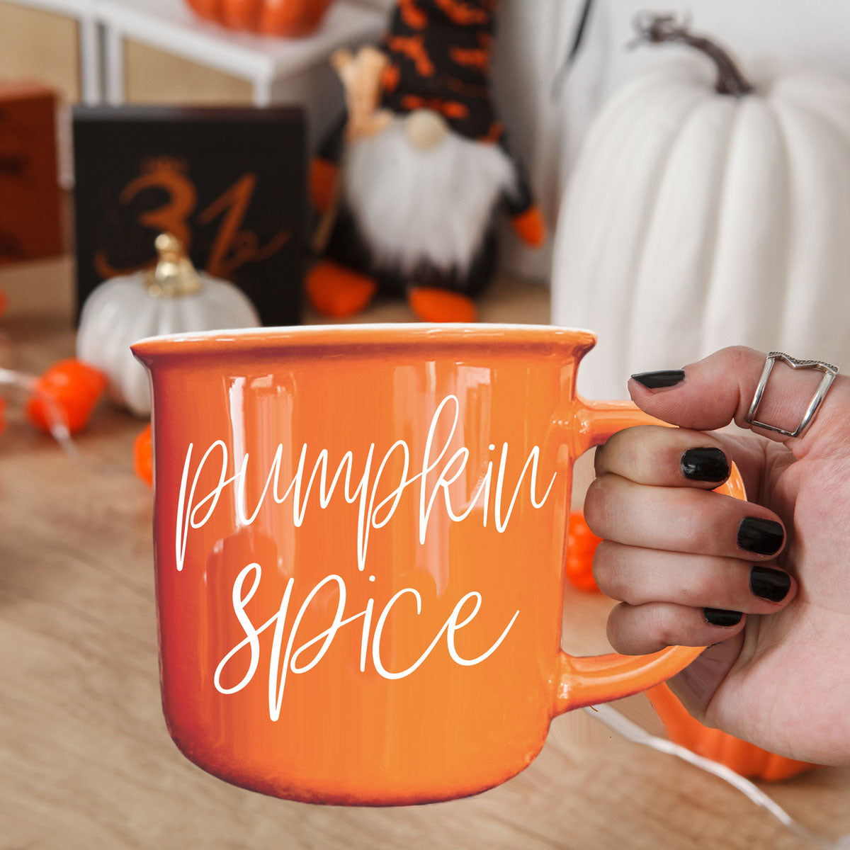 pumpkin spice fall mug with cozy socks
pumpkin spice mug on porch with mums and pumpkins
pumpkin spice latte mug next to pumpkin bread
pumpkin spice mug with acorns pinecones and leaves