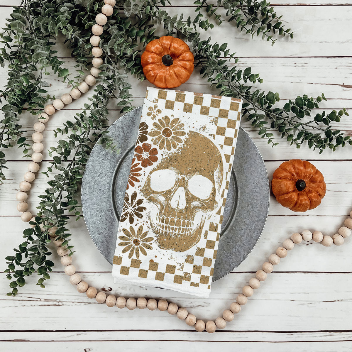 skull and ghost autumn kitchen towel for farmhouse décor
tan checkered halloween tea towel with floral skull art
warm neutral halloween towel for cozy fall kitchen