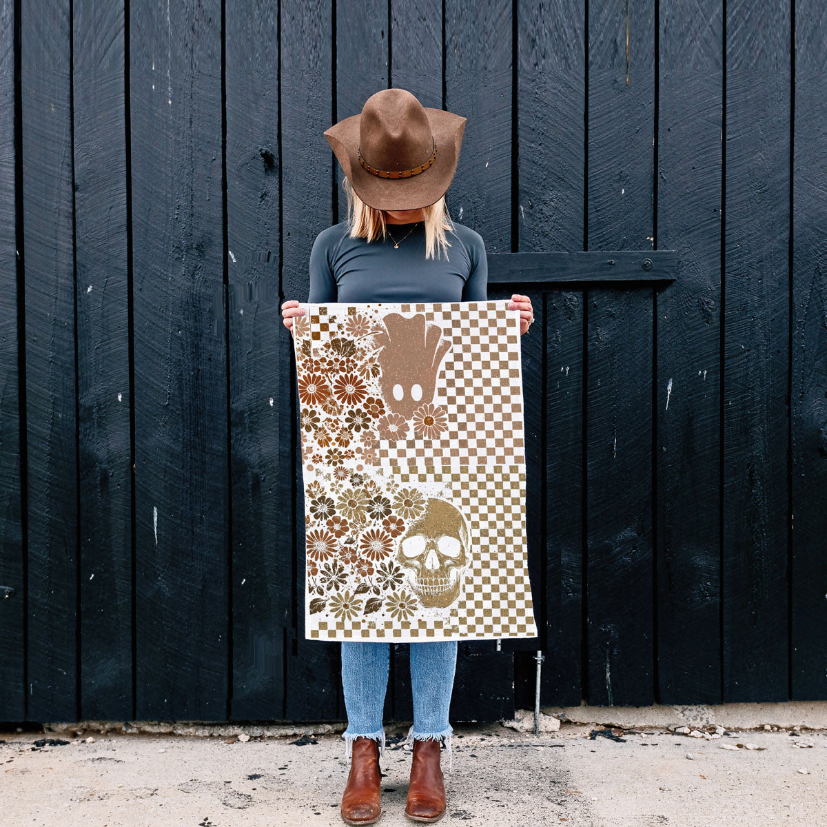 retro spooky vibes to your kitchen with this checkered skull and ghost Halloween towel. Featuring a tan and brown checkerboard pattern with daisies, a vintage-style skull and a cute ghost, this soft 100% flour sack cotton towel is perfect as a Halloween dish towel, tea towel or hand towel. 