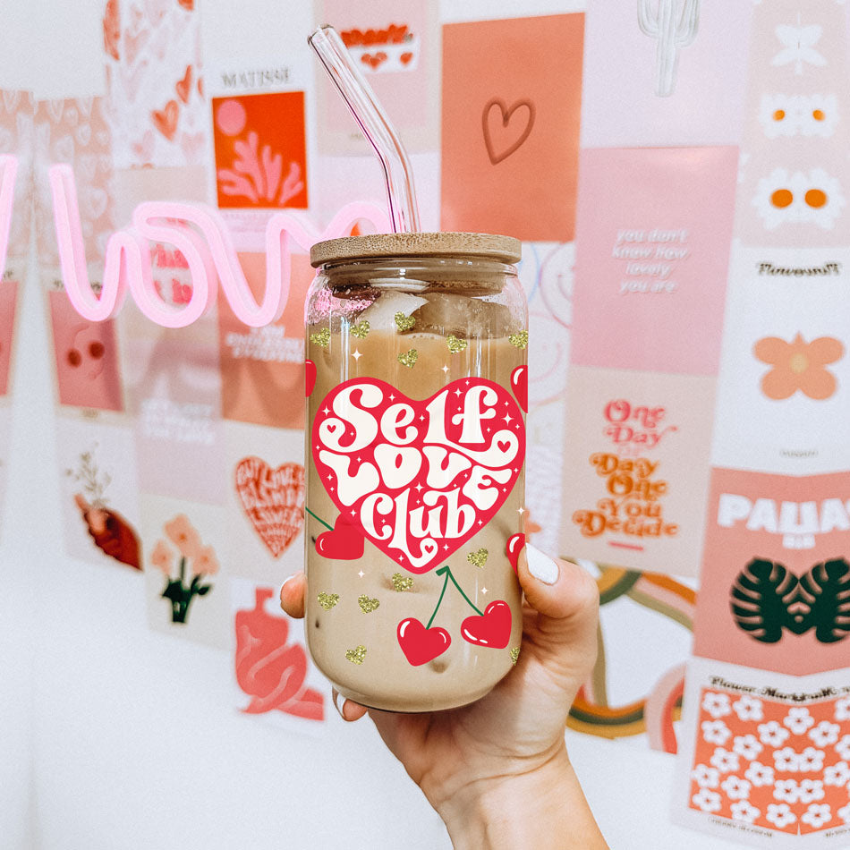 Self love club glass cup 20oz. 
20oz glass cups with bamboo lid and glass straw featuring "Self Love Club" and red heart cherry graphics.
Retro "Self Love Club" 20oz glass cups with bamboo lid, glass straw, and gold glitter hearts.