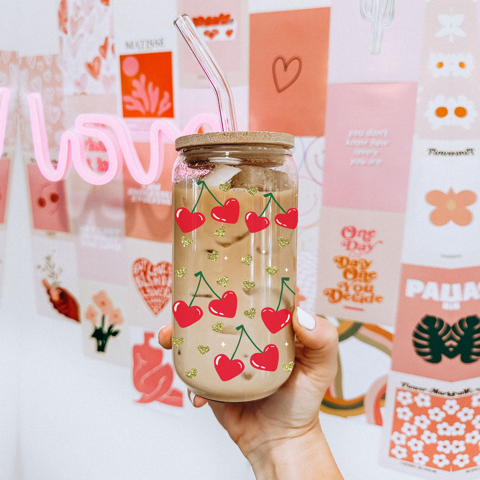 Chic 20oz glass cups with bamboo lid and glass straw, featuring red heart and cherry graphics.
"Self Love Club" 20oz glass cups with bamboo lid, glass straw, and gold glitter hearts for a unique gift.