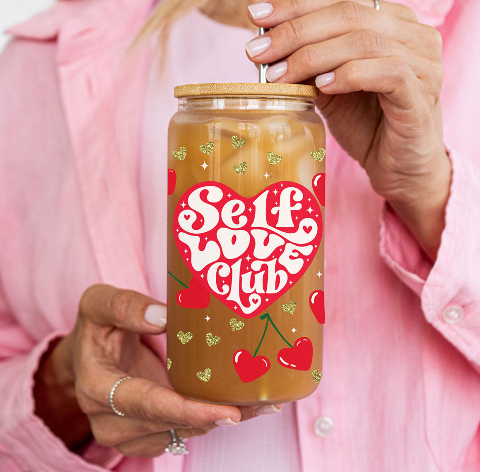 20oz glass cups with bamboo lid and glass straw, designed for self growth and self love gifts for women.
Self Love Club 20oz glass cups with bamboo lid, glass straw, and red heart graphics for a unique women empowerment gift.