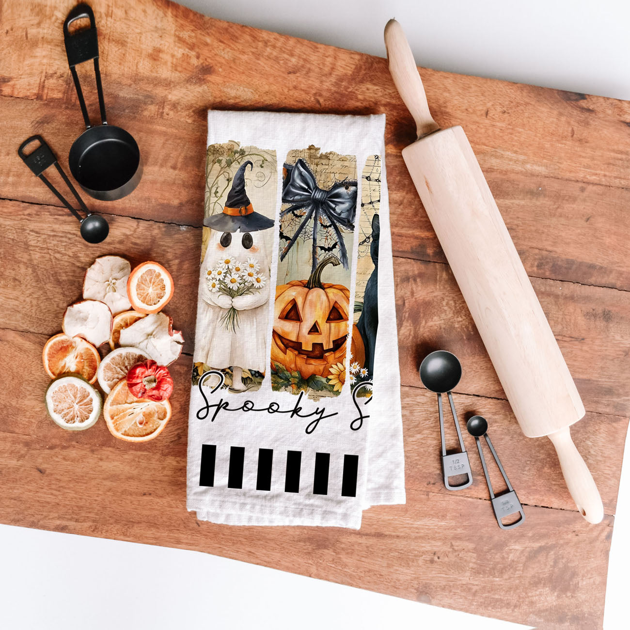 black and white striped halloween towel with ghost panel
spooky season tea towel for black cat lovers
unique halloween gift towel with ghost and grave illustration
spooky season dish towel draped over oven handle