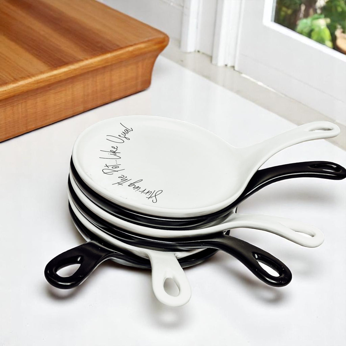 White ceramic spoon rest with cursive Stirring the Pot quote
Black ceramic spoon rest with bold Stirring the Pot text