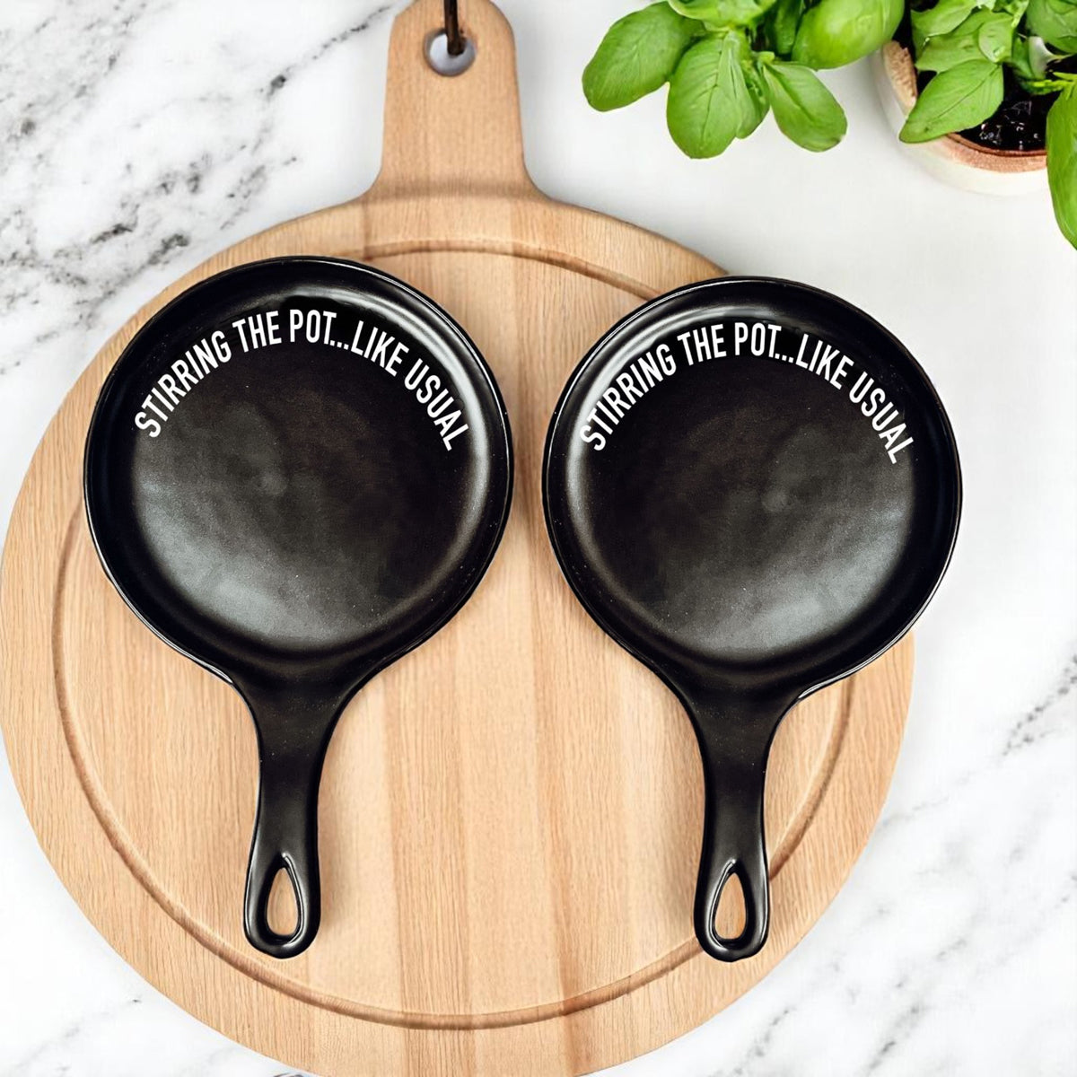 Black and white ceramic spoon rest set with Stirring the Pot Like Usual quote
Modern kitchen spoon rest with sassy cooking quote and wooden spoon