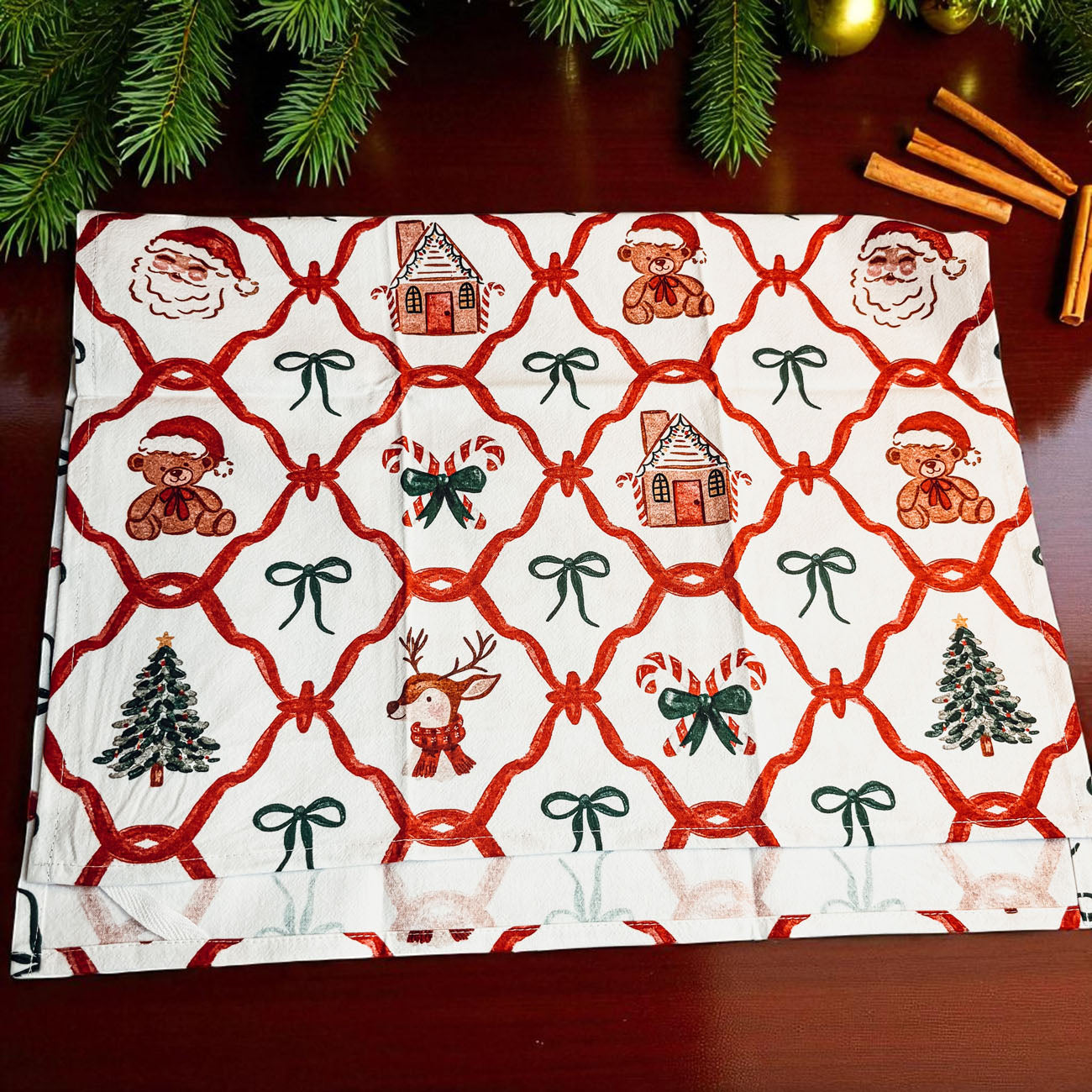 red and green christmas towel with classic holiday icons
gingerbread and santa claus holiday kitchen towel
christmas tea towel with reindeer, santa, and candy canes