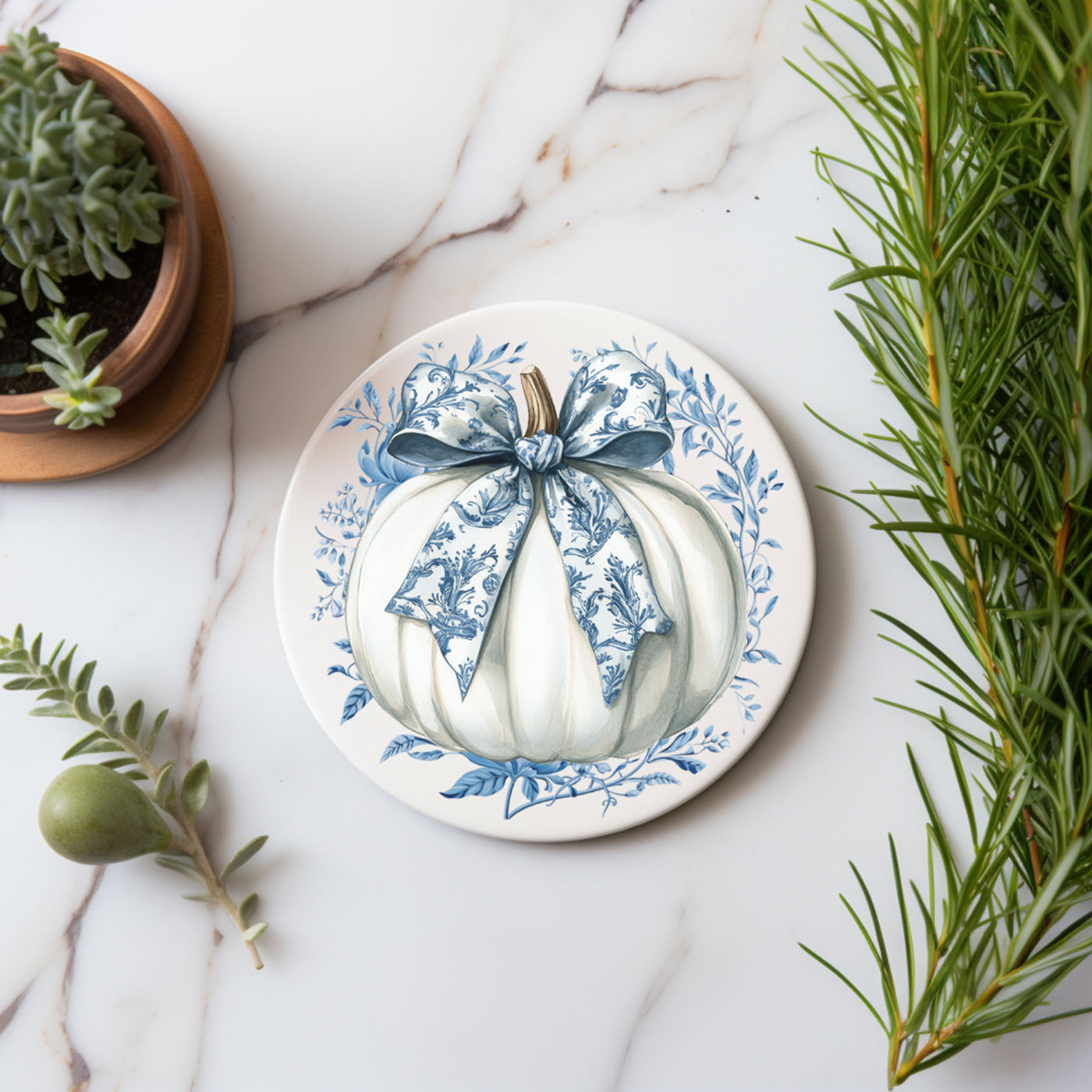 Blue chinoiserie pumpkin coaster with intricate pattern details
White pumpkin coaster with blue bow and floral chinoiserie design